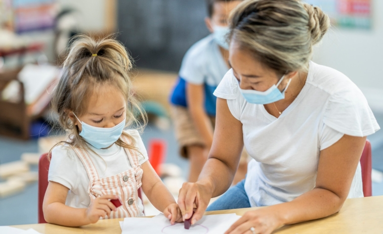 a person and a girl looking at a paper