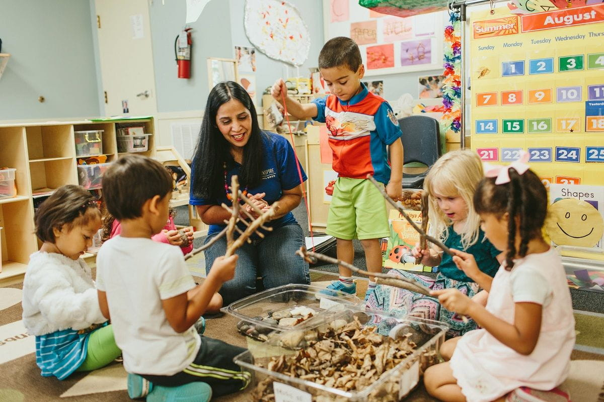 a person and children in a classroom