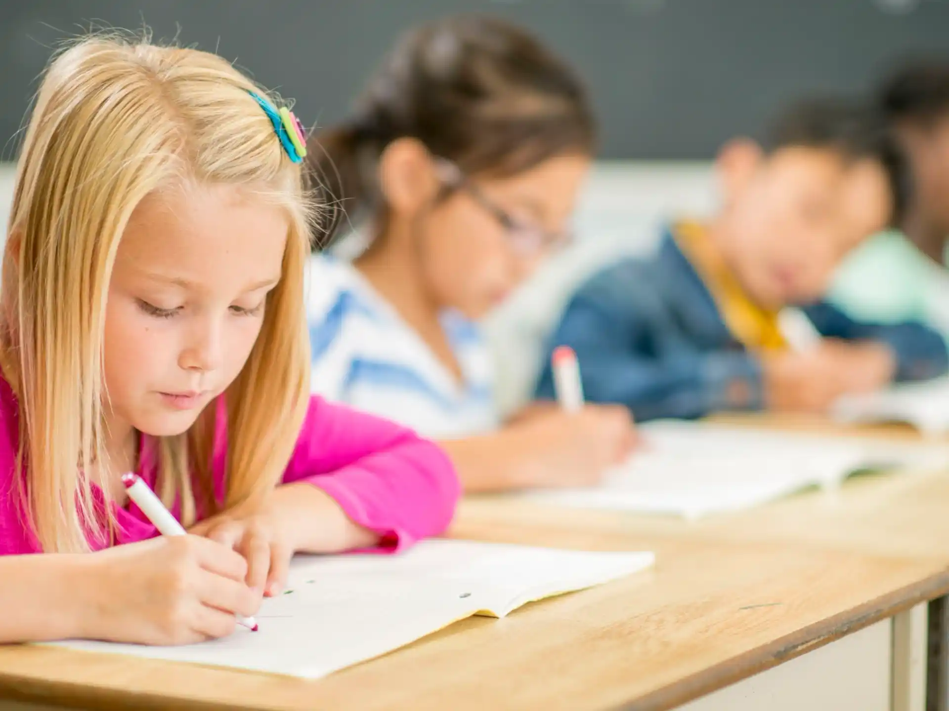 a girl writing on a book