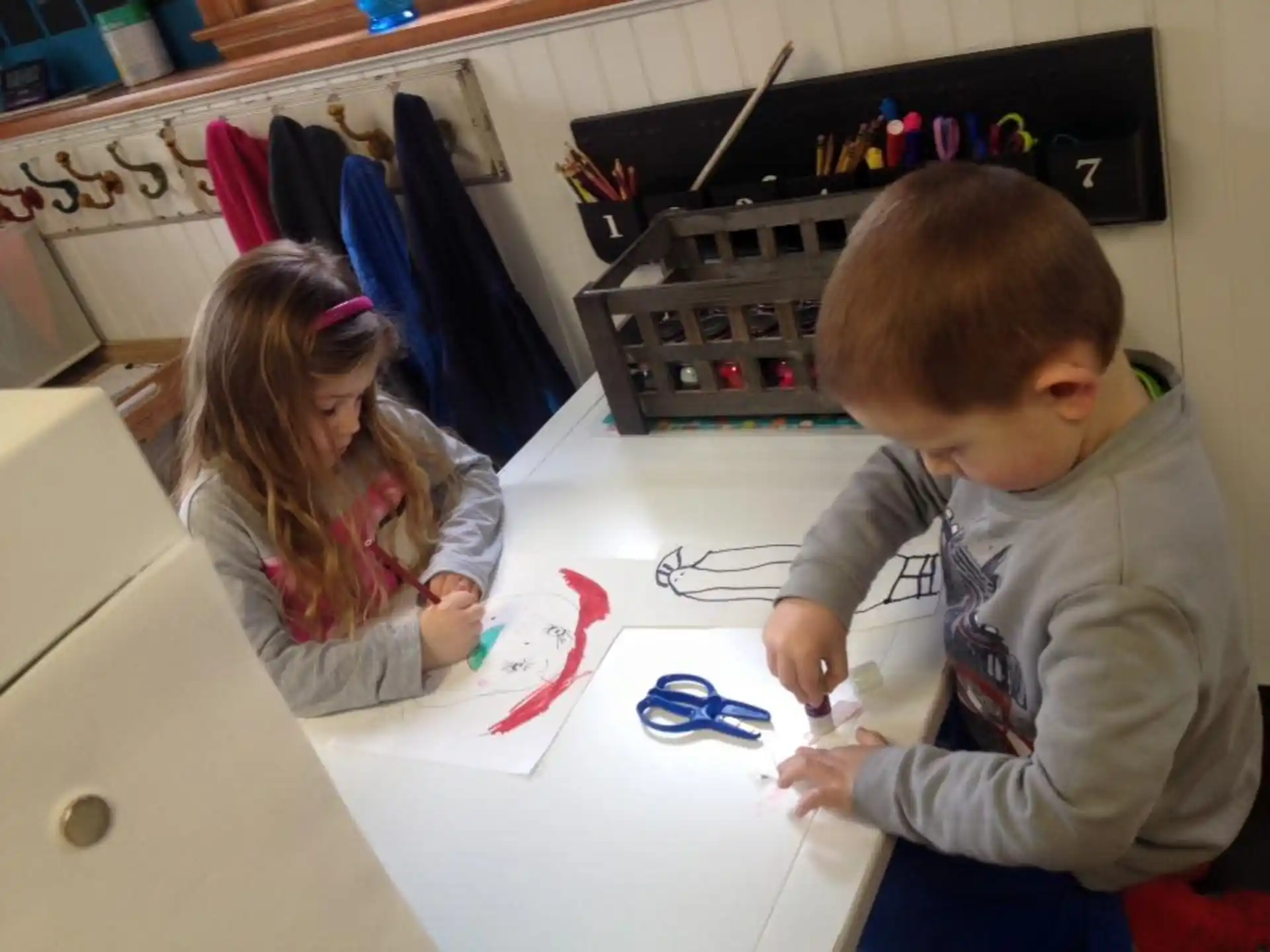 a boy and girl playing with a toy