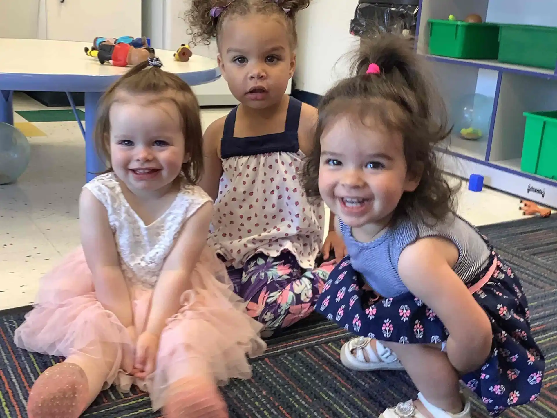 a group of girls sitting on the floor