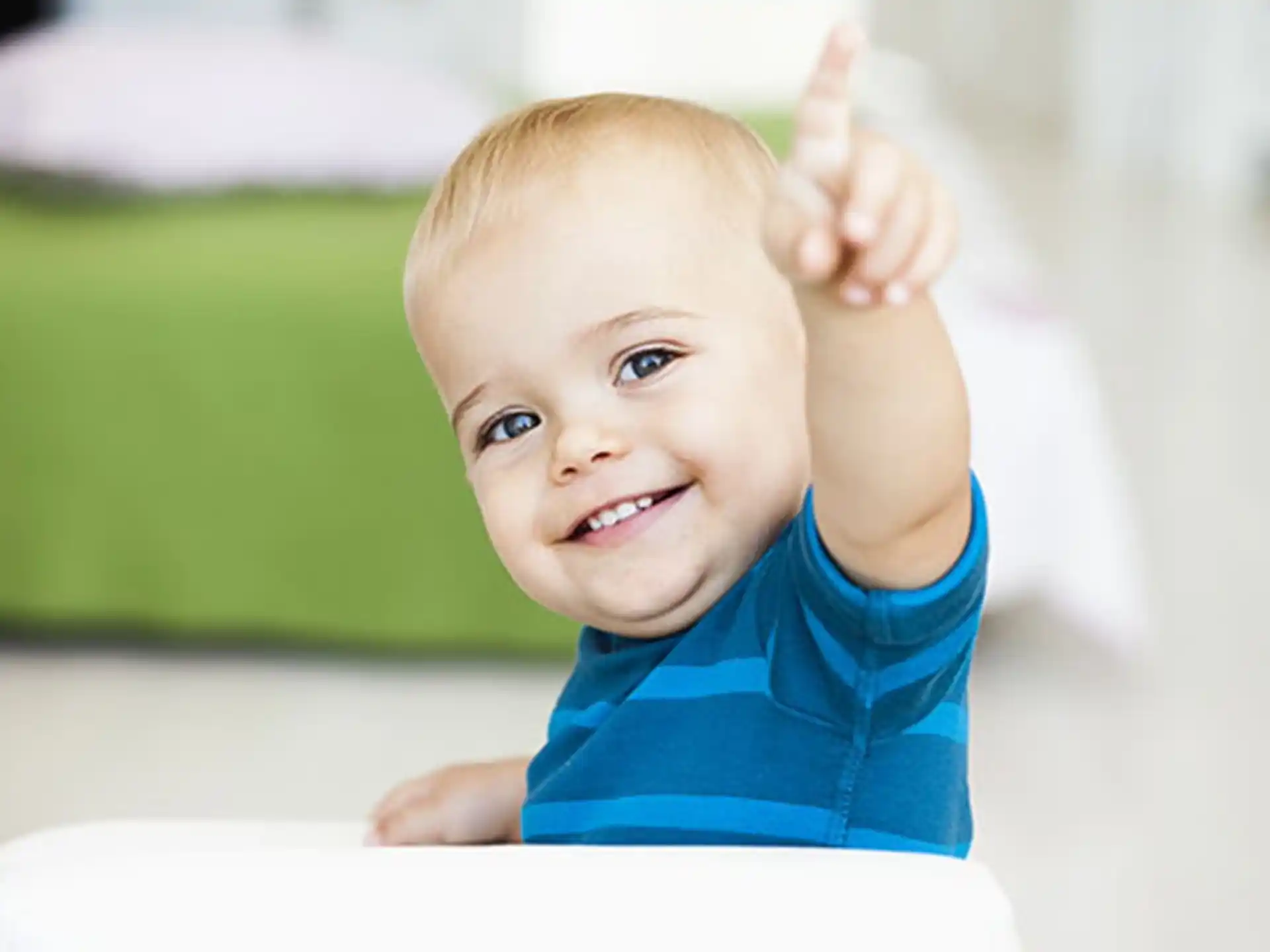 a baby with a thumbs up