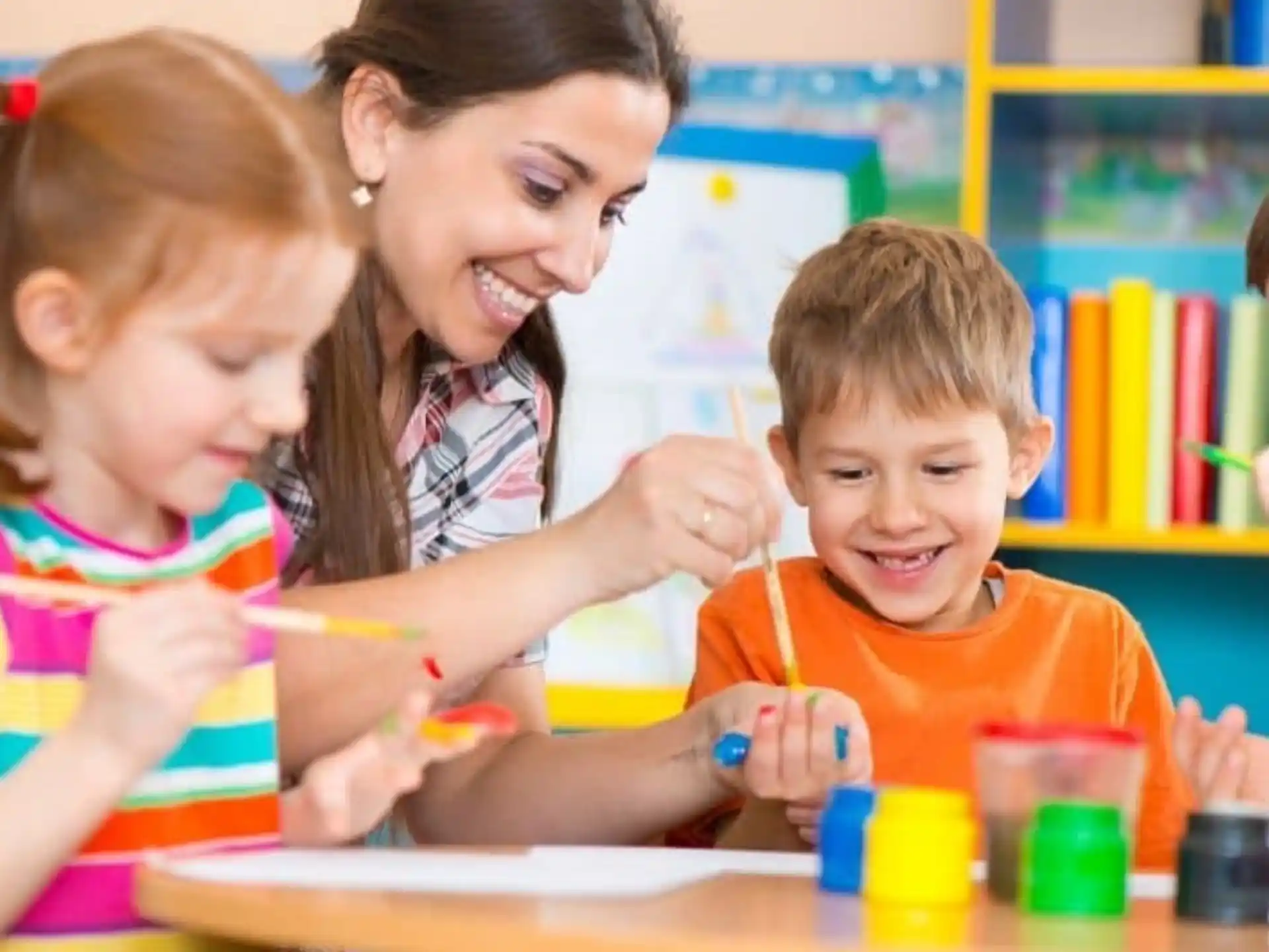 a person and children painting
