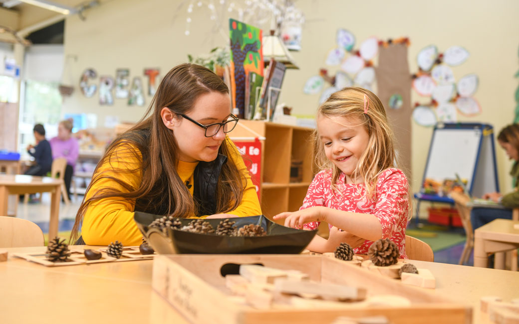 a young girl and a young girl playing a board game
