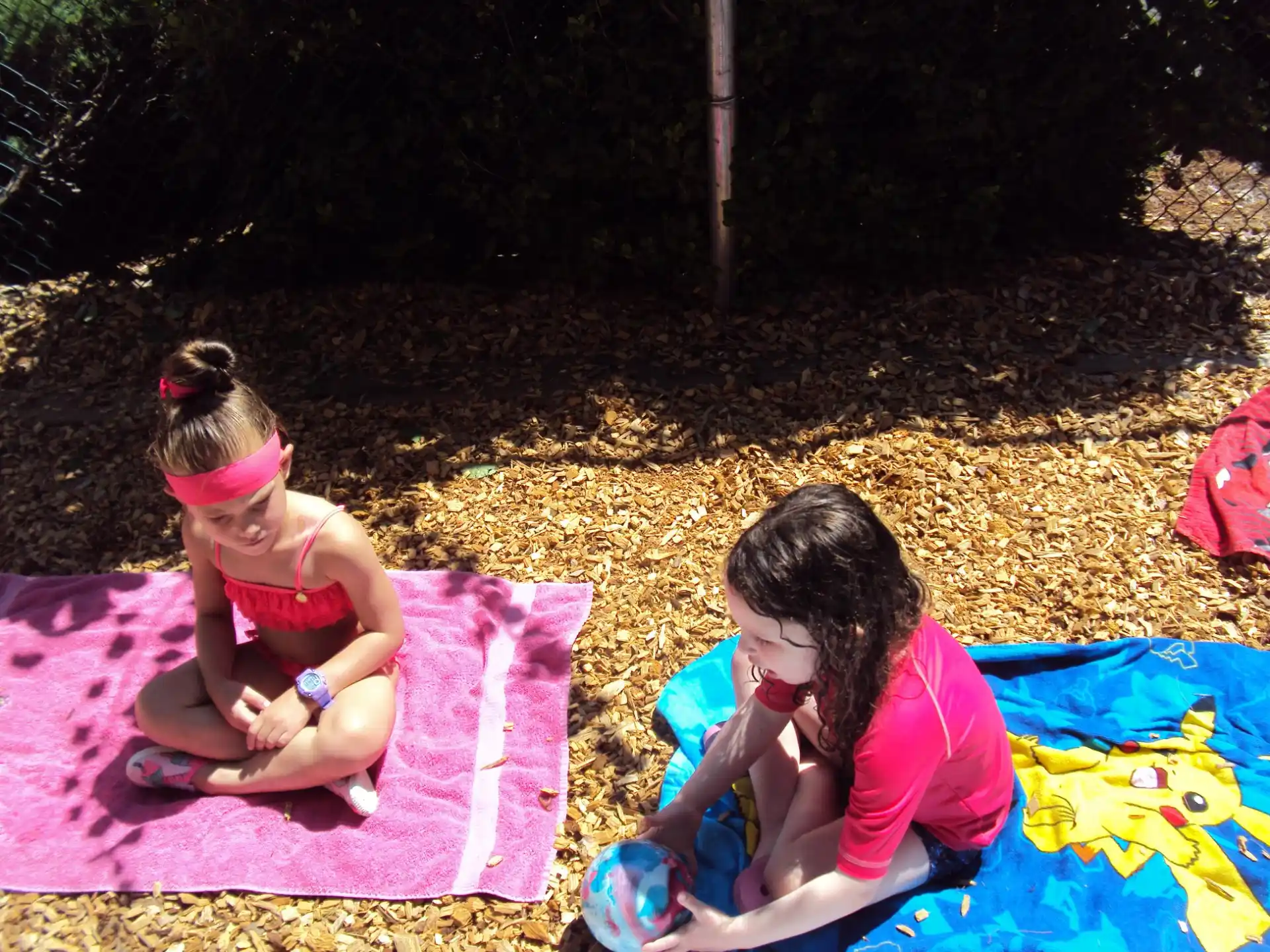 two girls sitting on a blanket