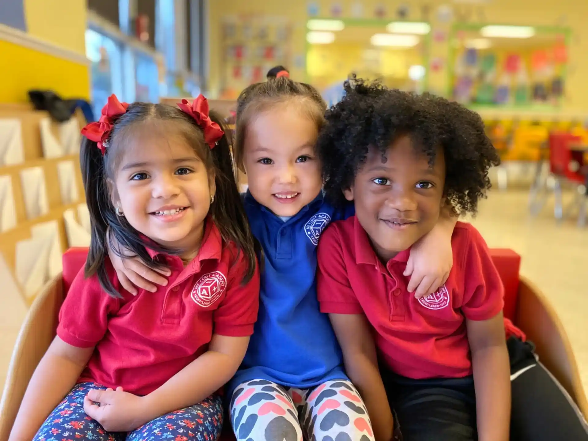 a group of children sitting together smiling