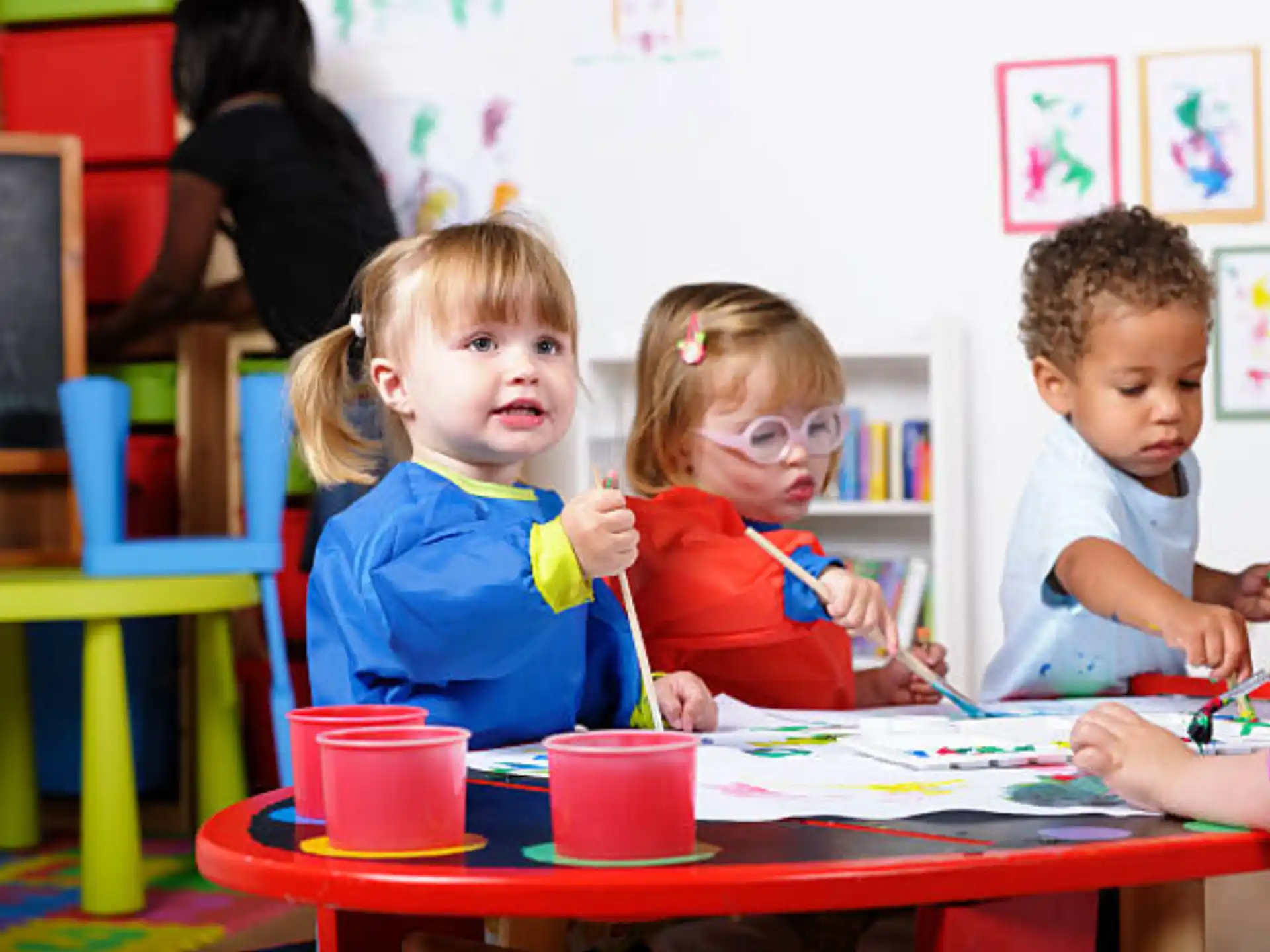 a group of children sitting at a table