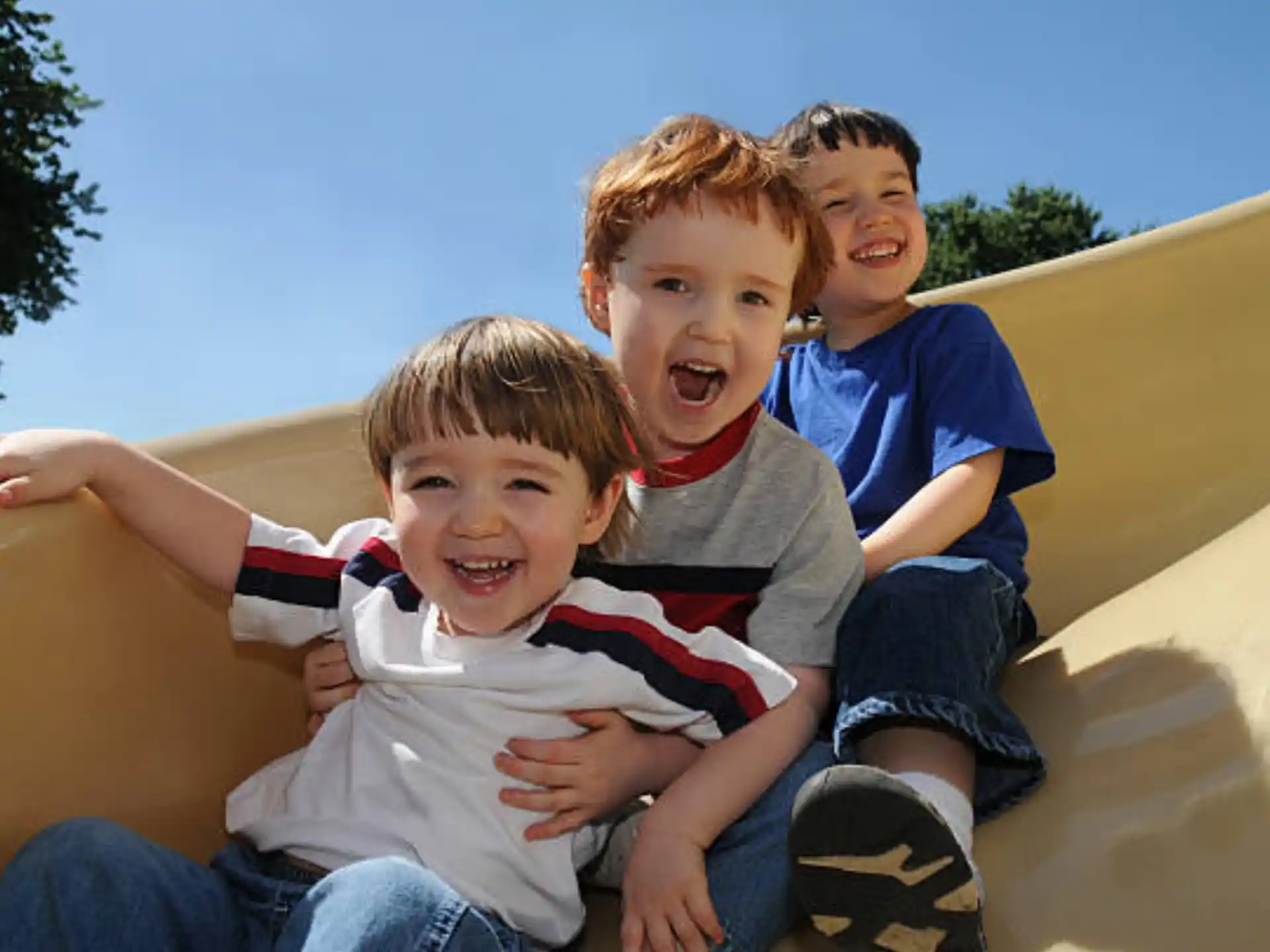 a group of kids sitting on a slide