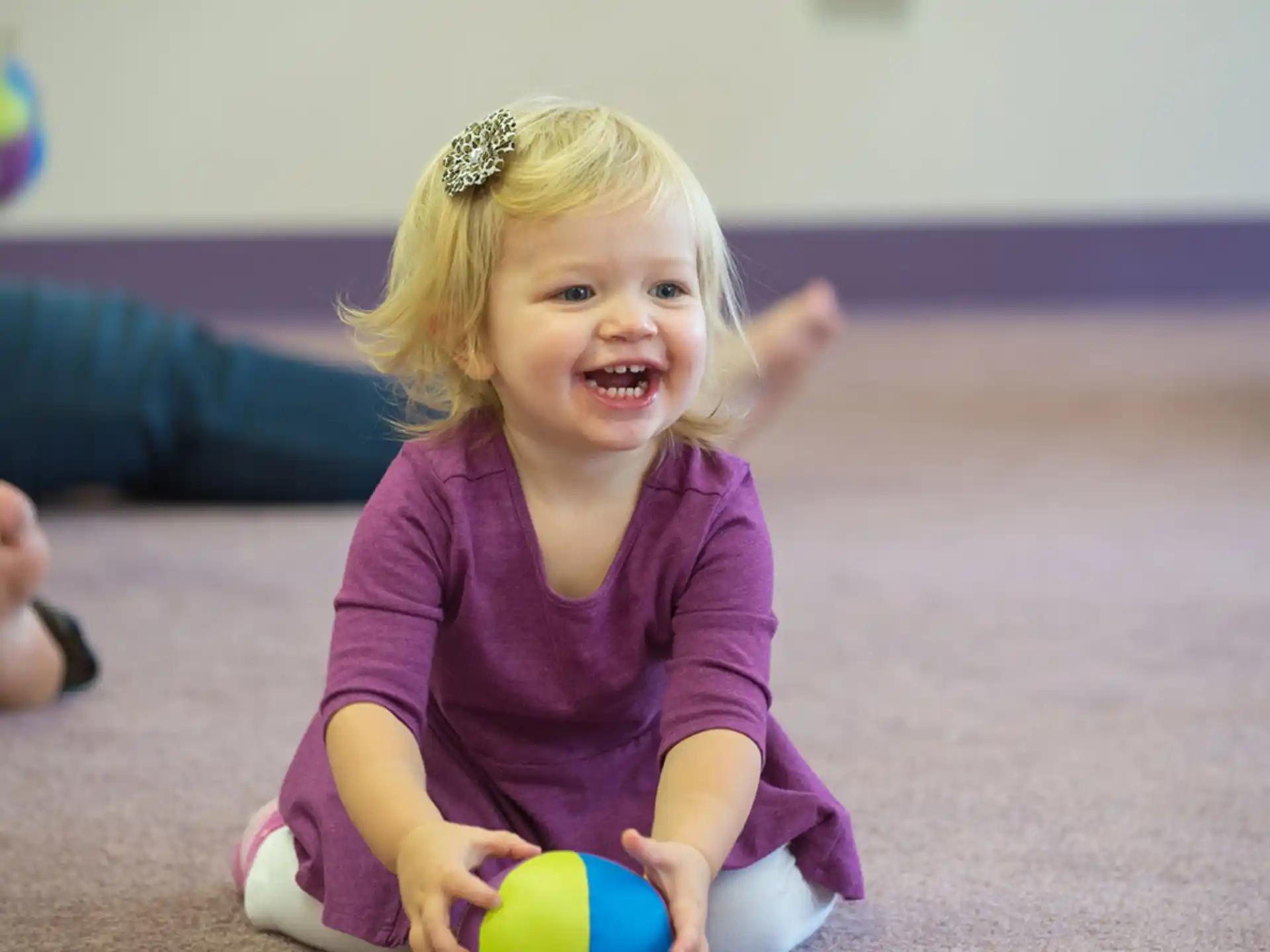 a little girl sitting on the floor