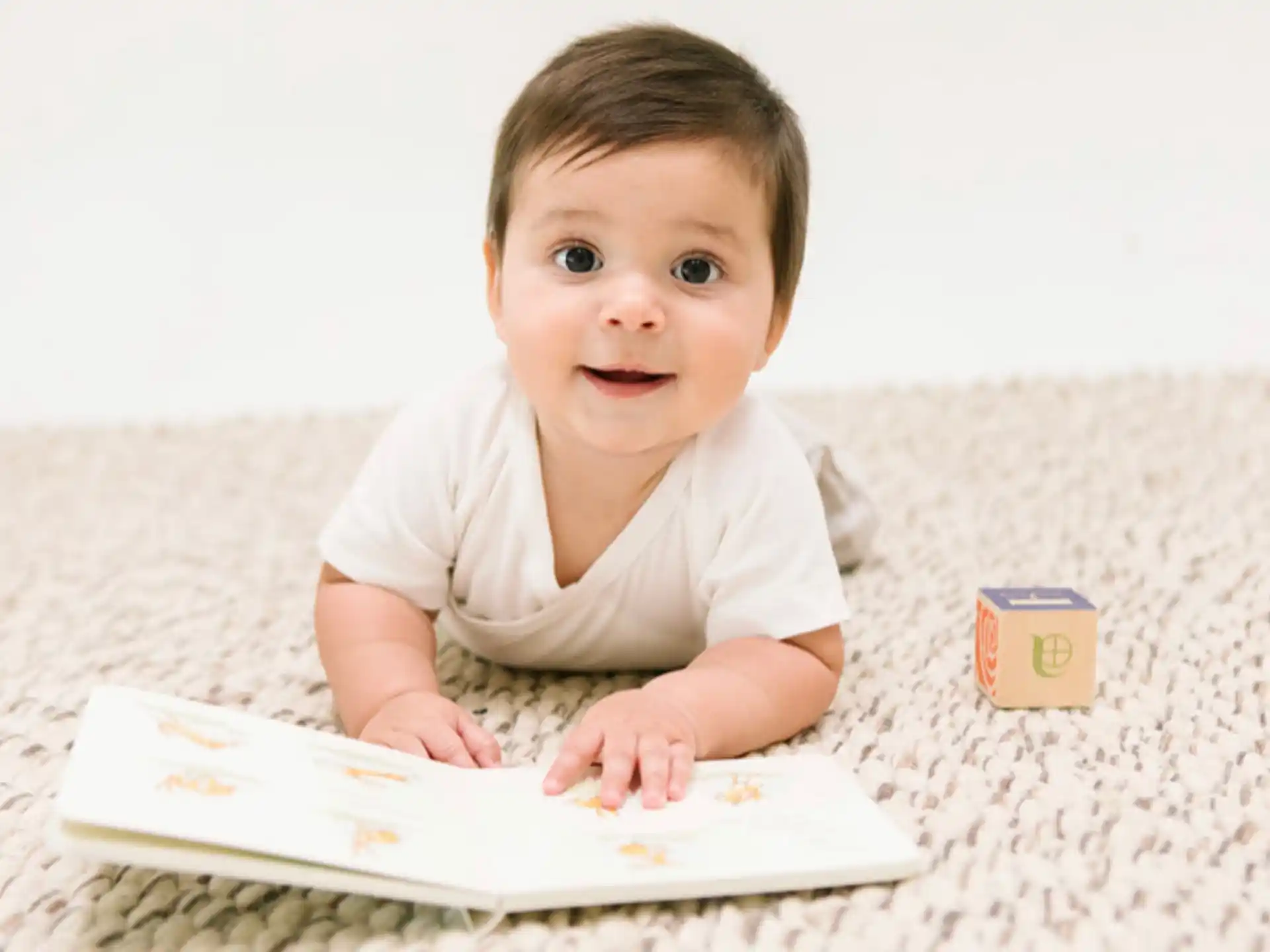 a baby lying on a bed