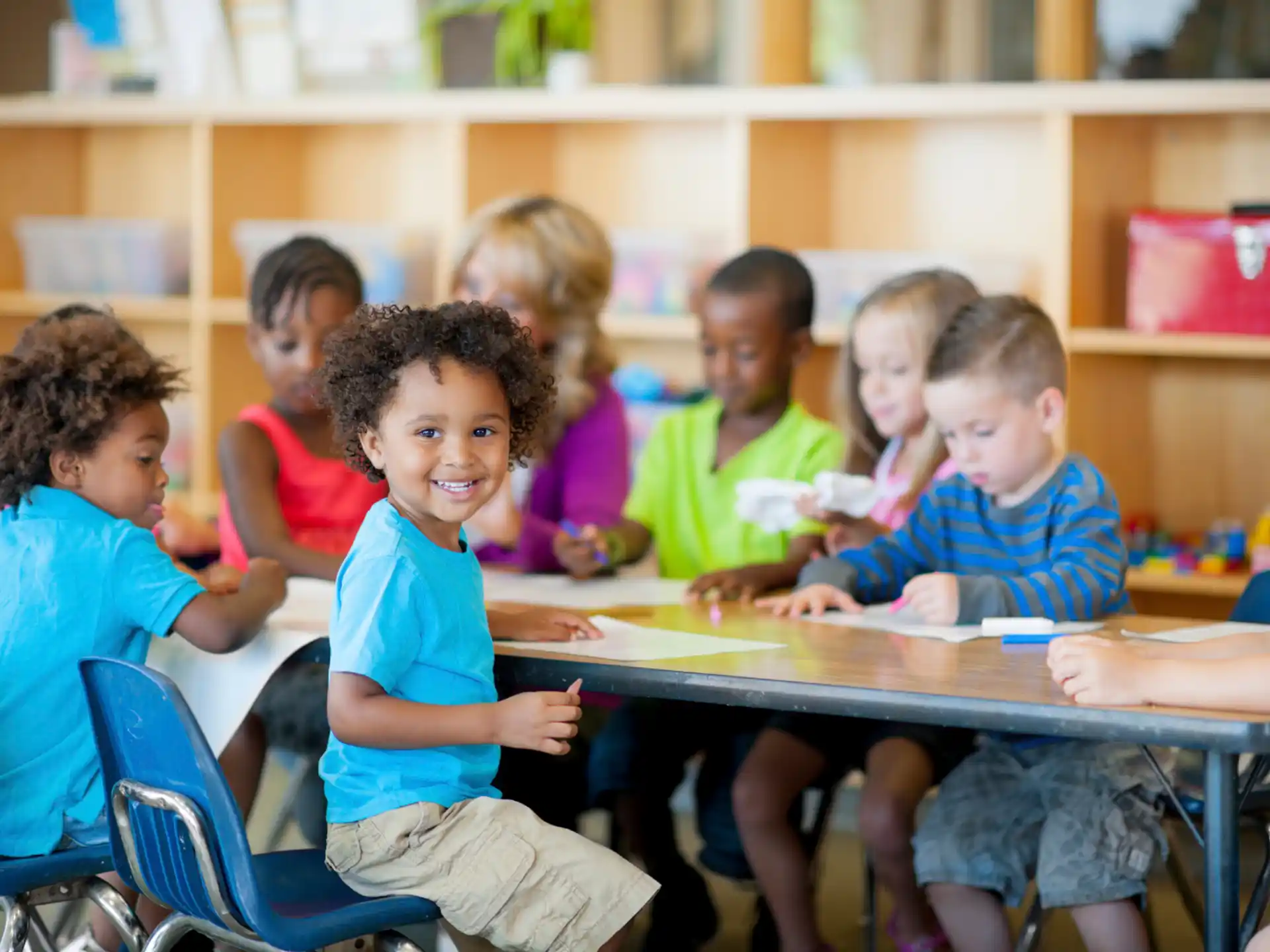 a group of children sitting at a table