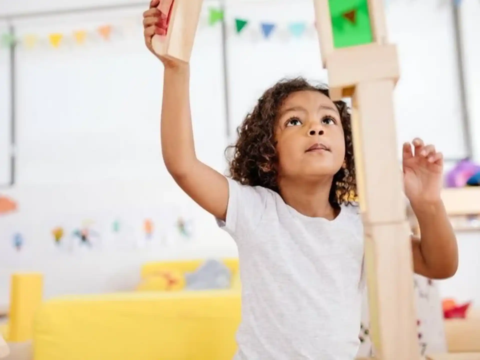 a young girl raising her hands