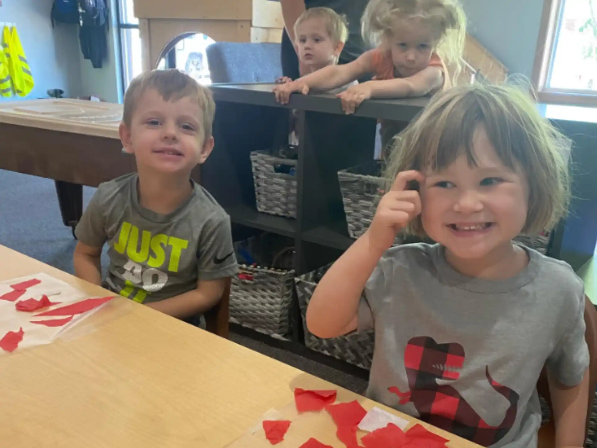 a group of children sitting at a table