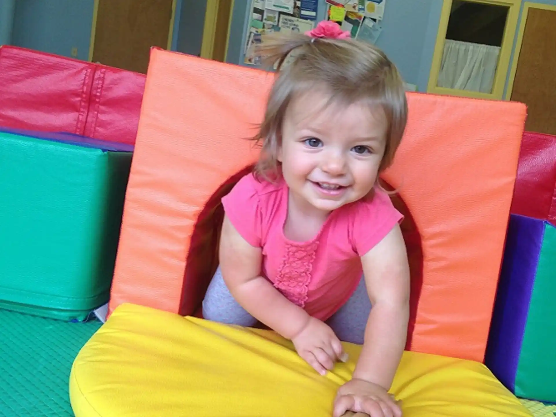 a child sitting in a ball pit