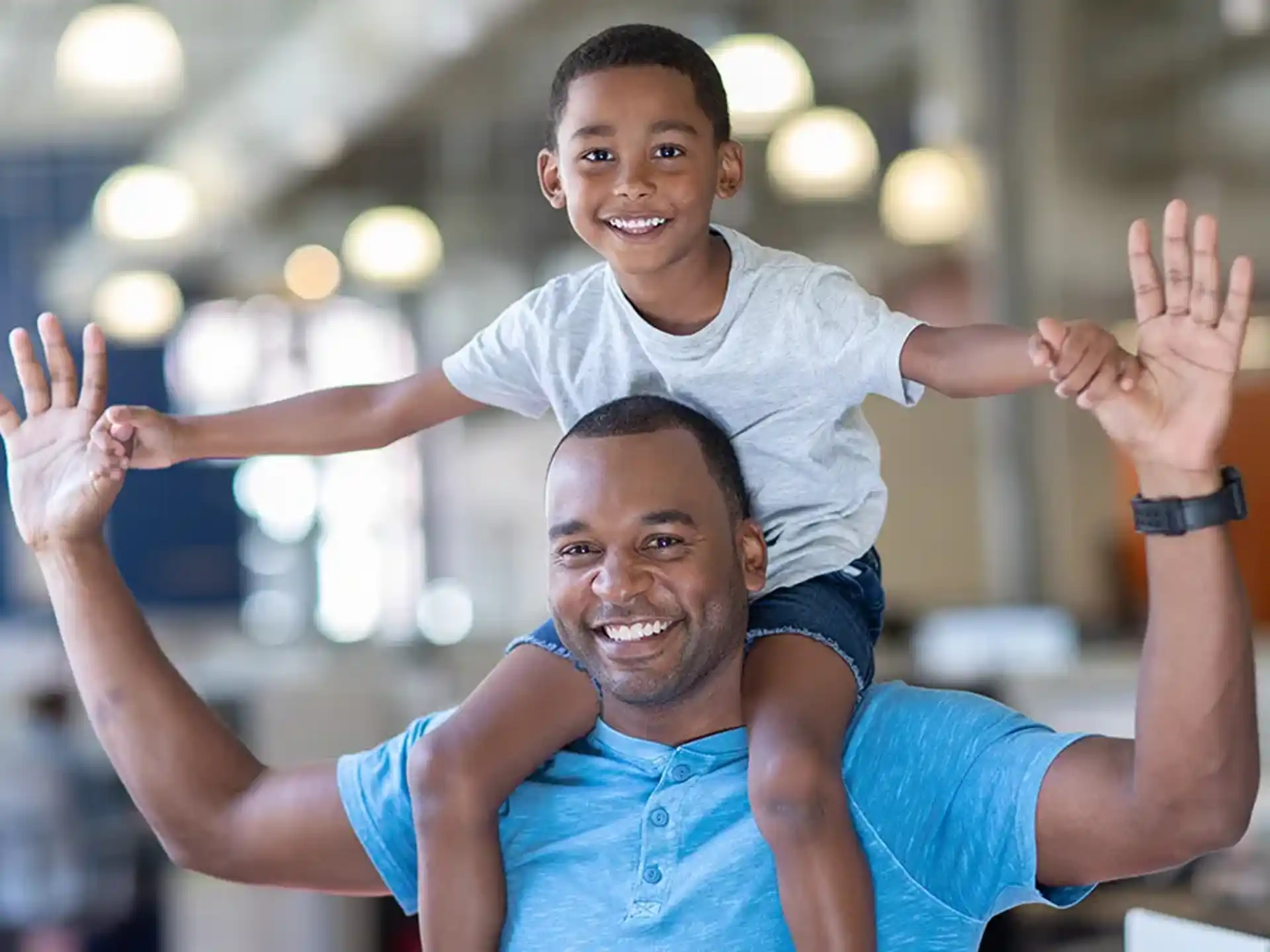 a person holding a child on the shoulders