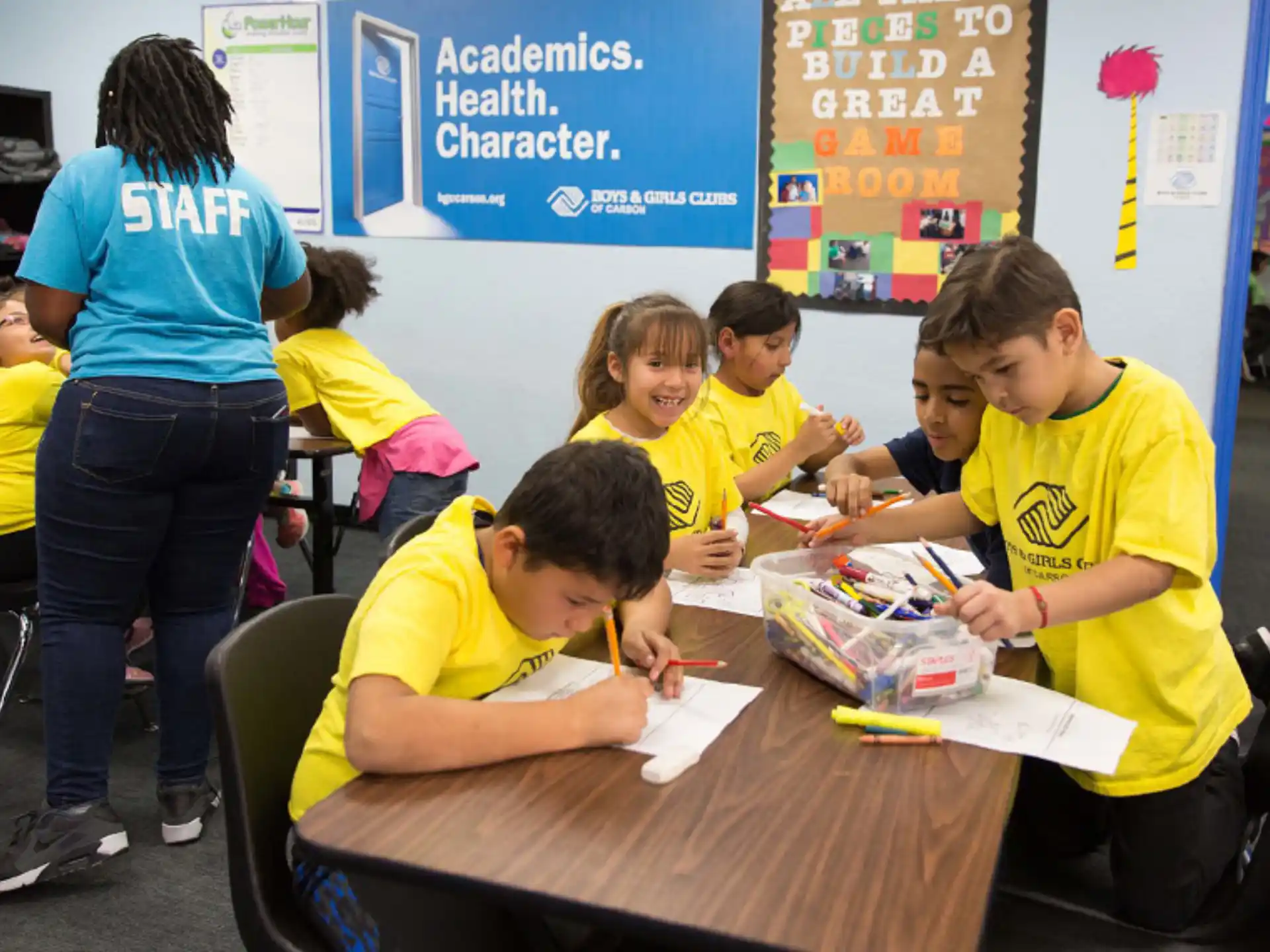 a group of children sitting at a table