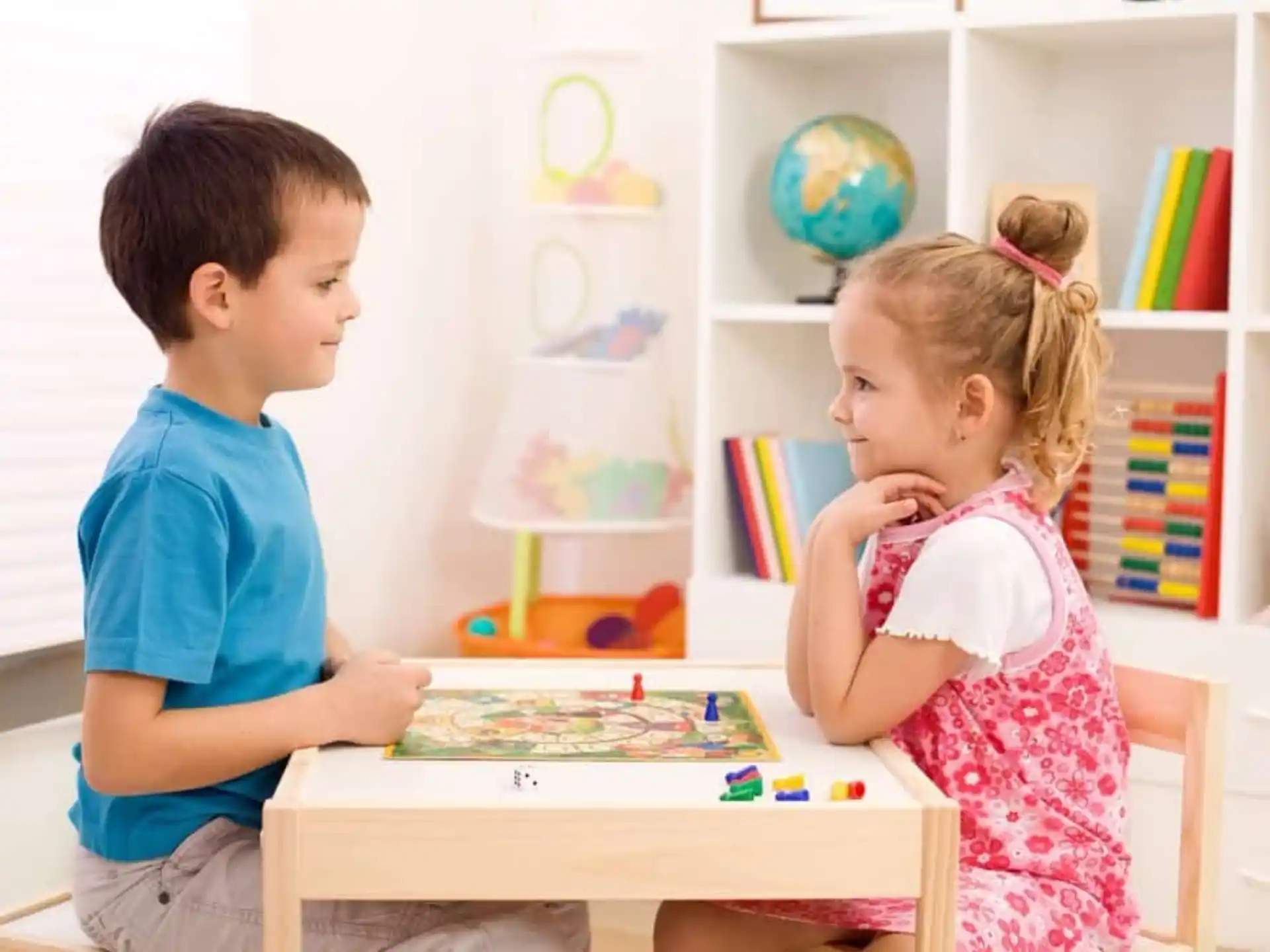 a boy and girl playing a board game
