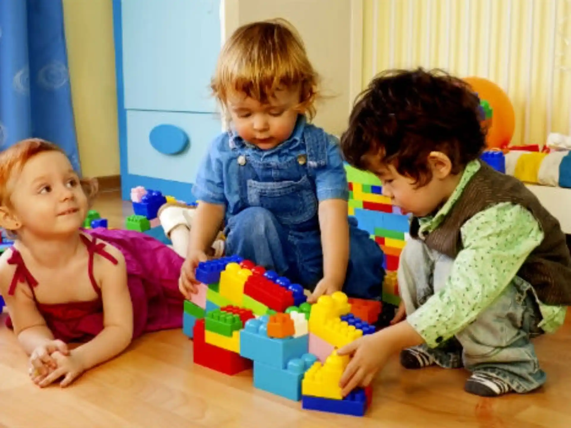 a group of children playing with toys