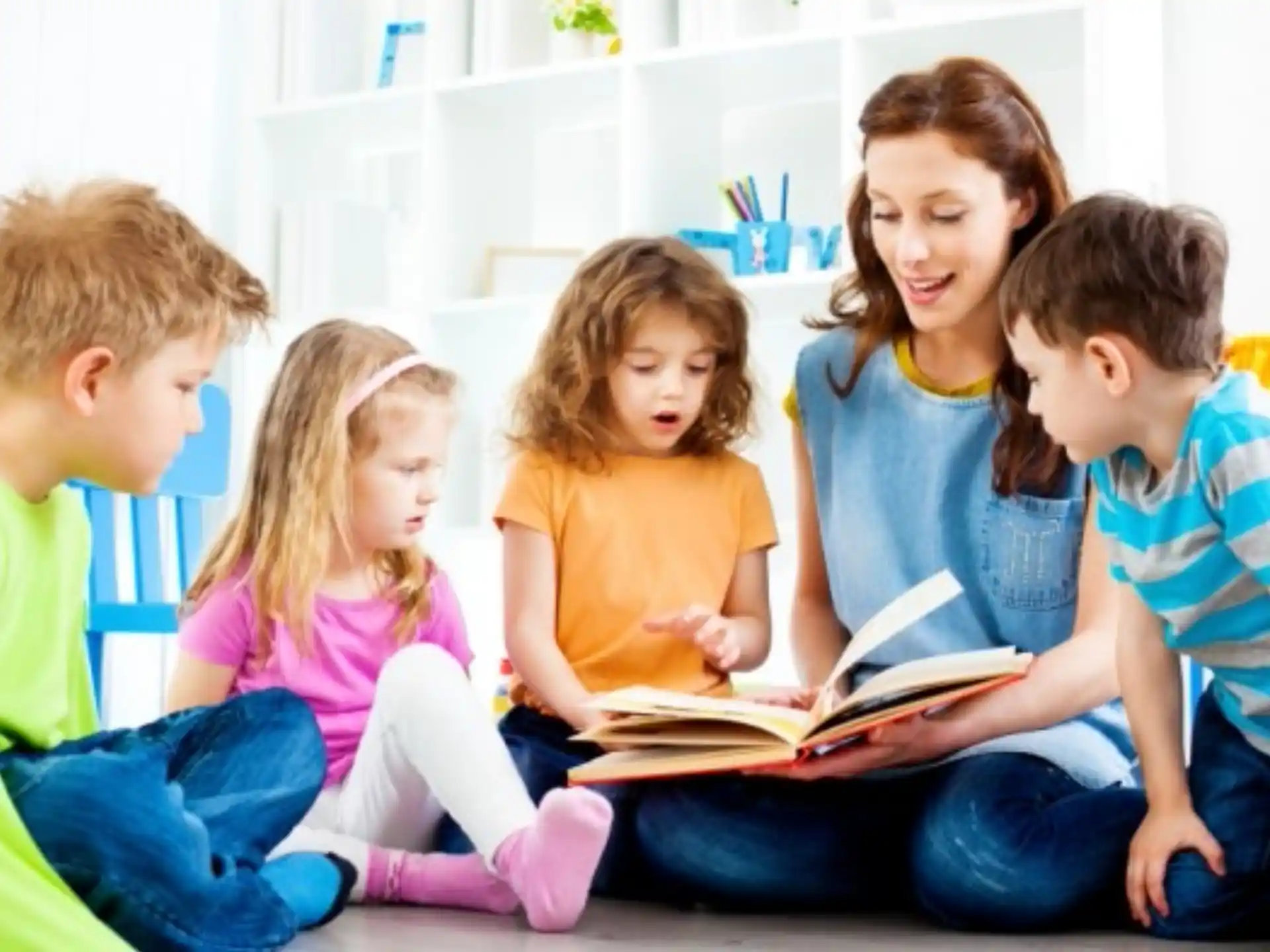 a group of children reading a book