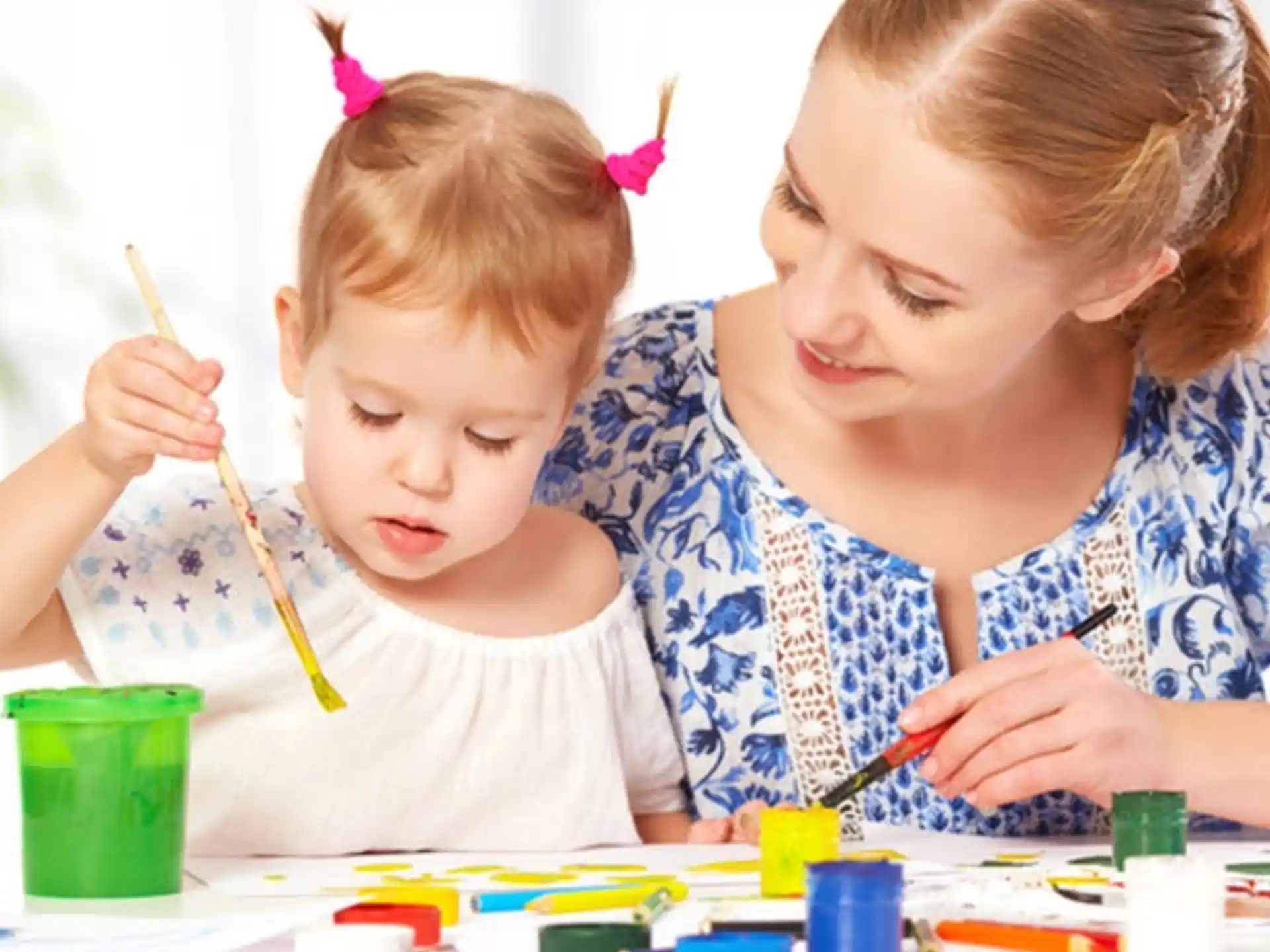 a person and a child painting