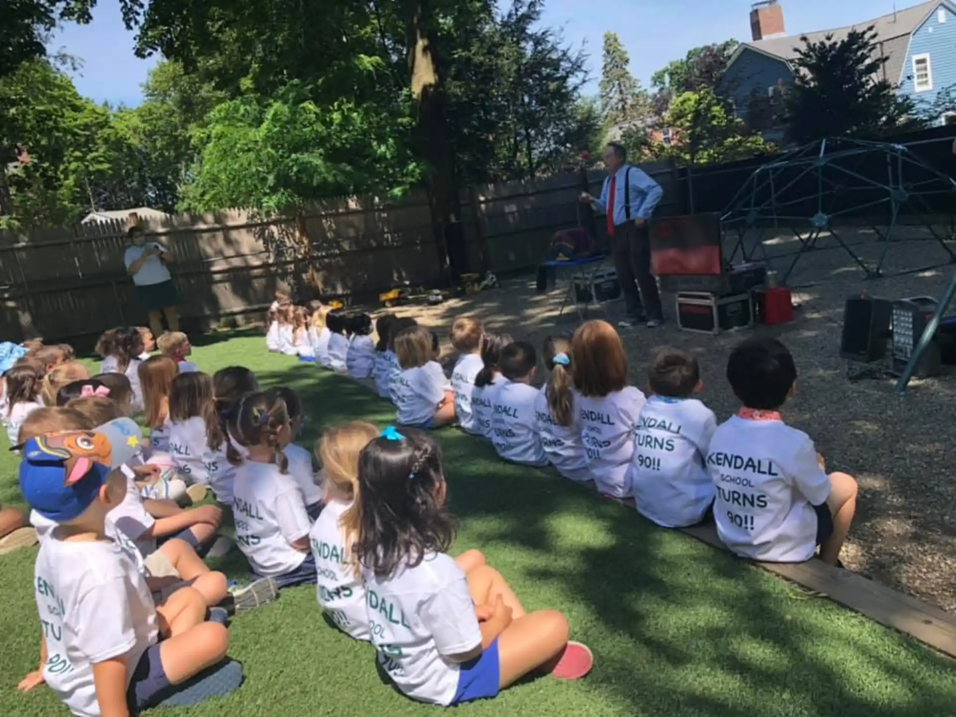 a group of children sitting on the grass