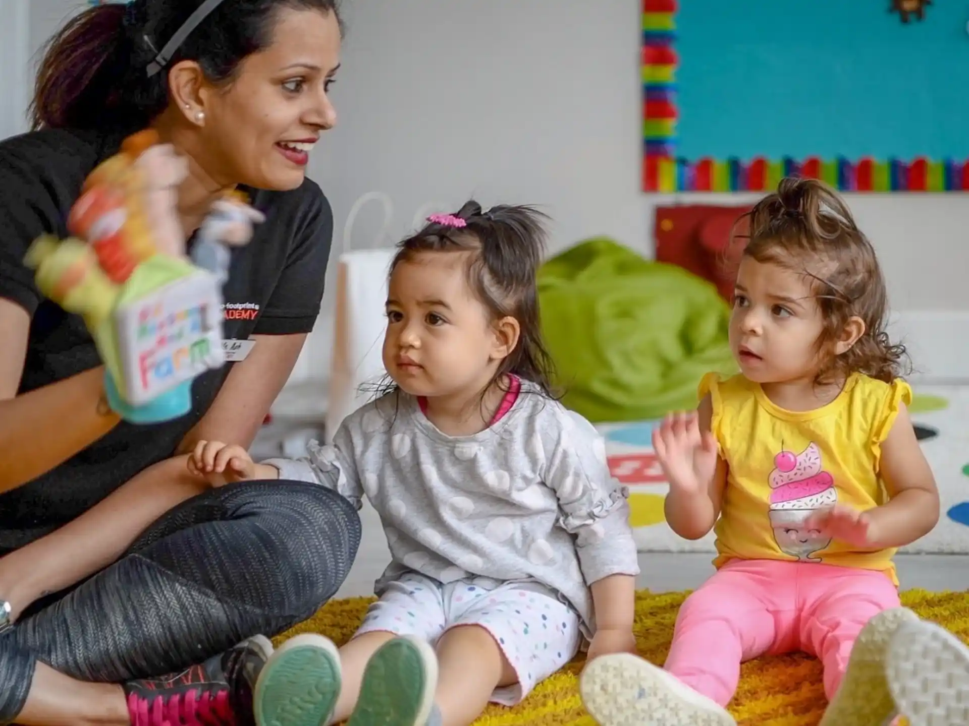 a person and two children sitting on the floor