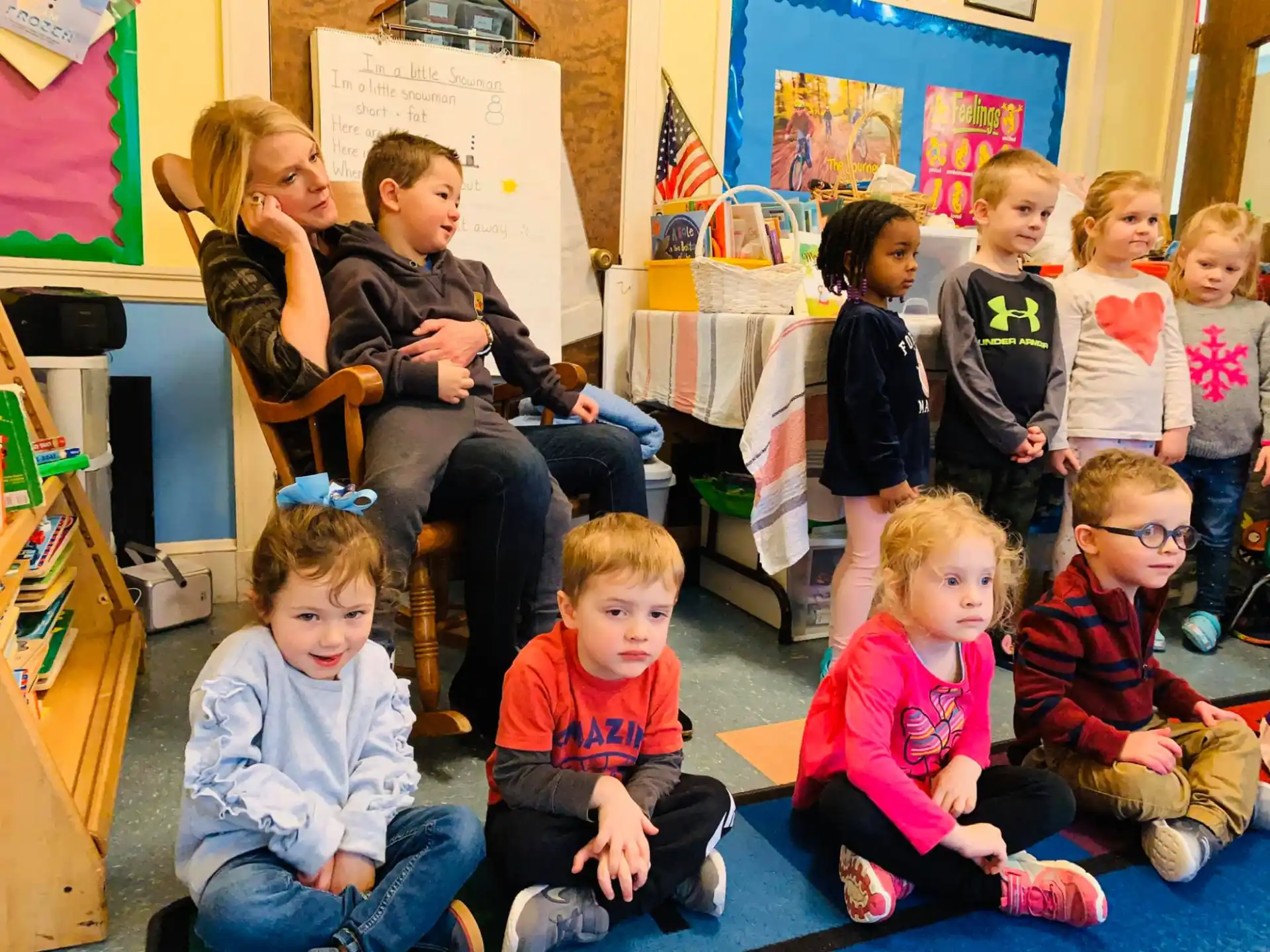 a group of children sitting in a classroom