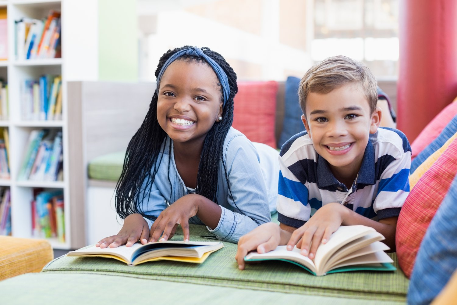 a person and a boy reading a book