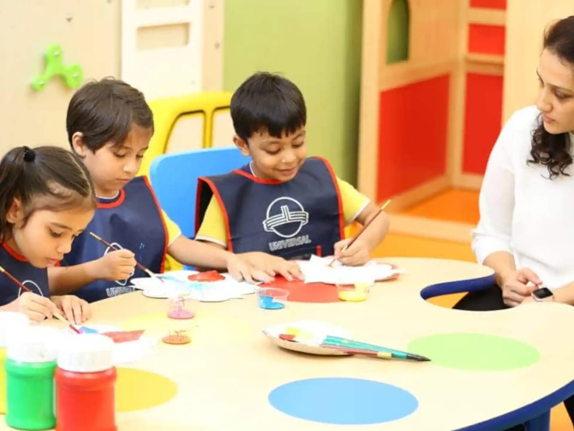 a group of children sitting at a table