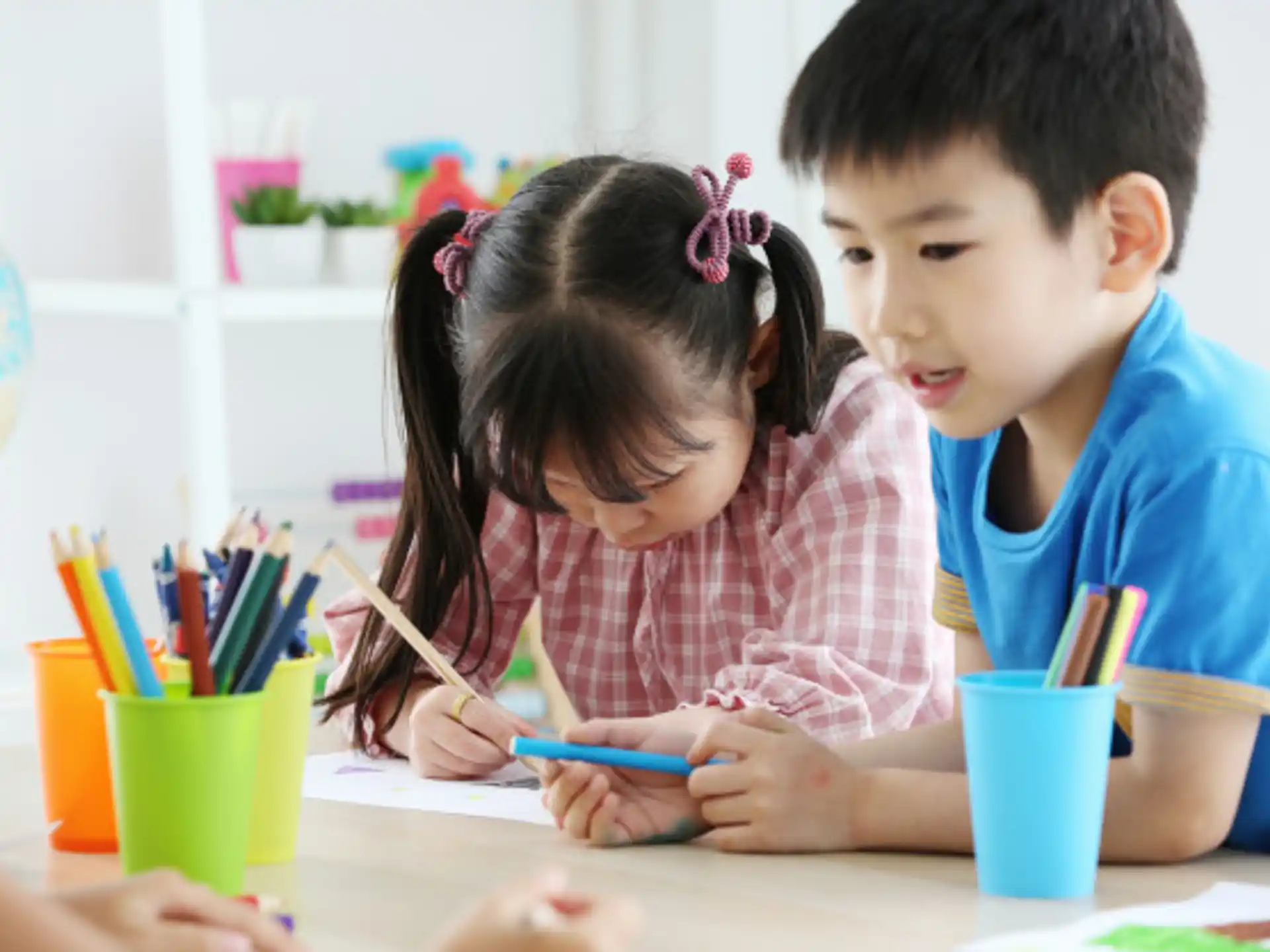 a couple of children painting