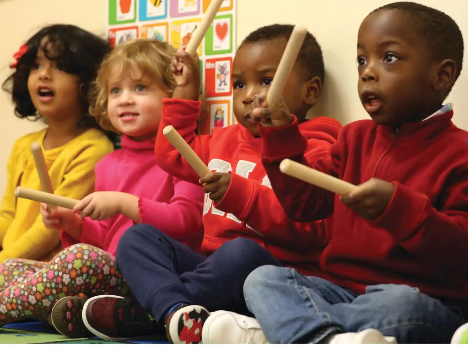 a group of children holding pencils