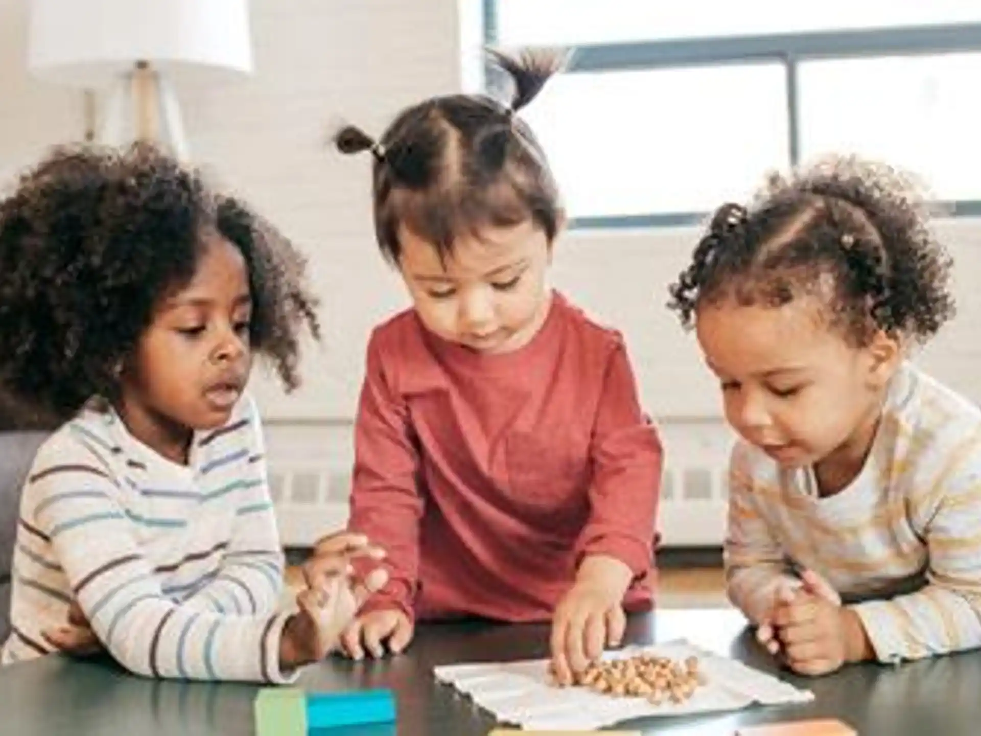 a group of children sitting at a table