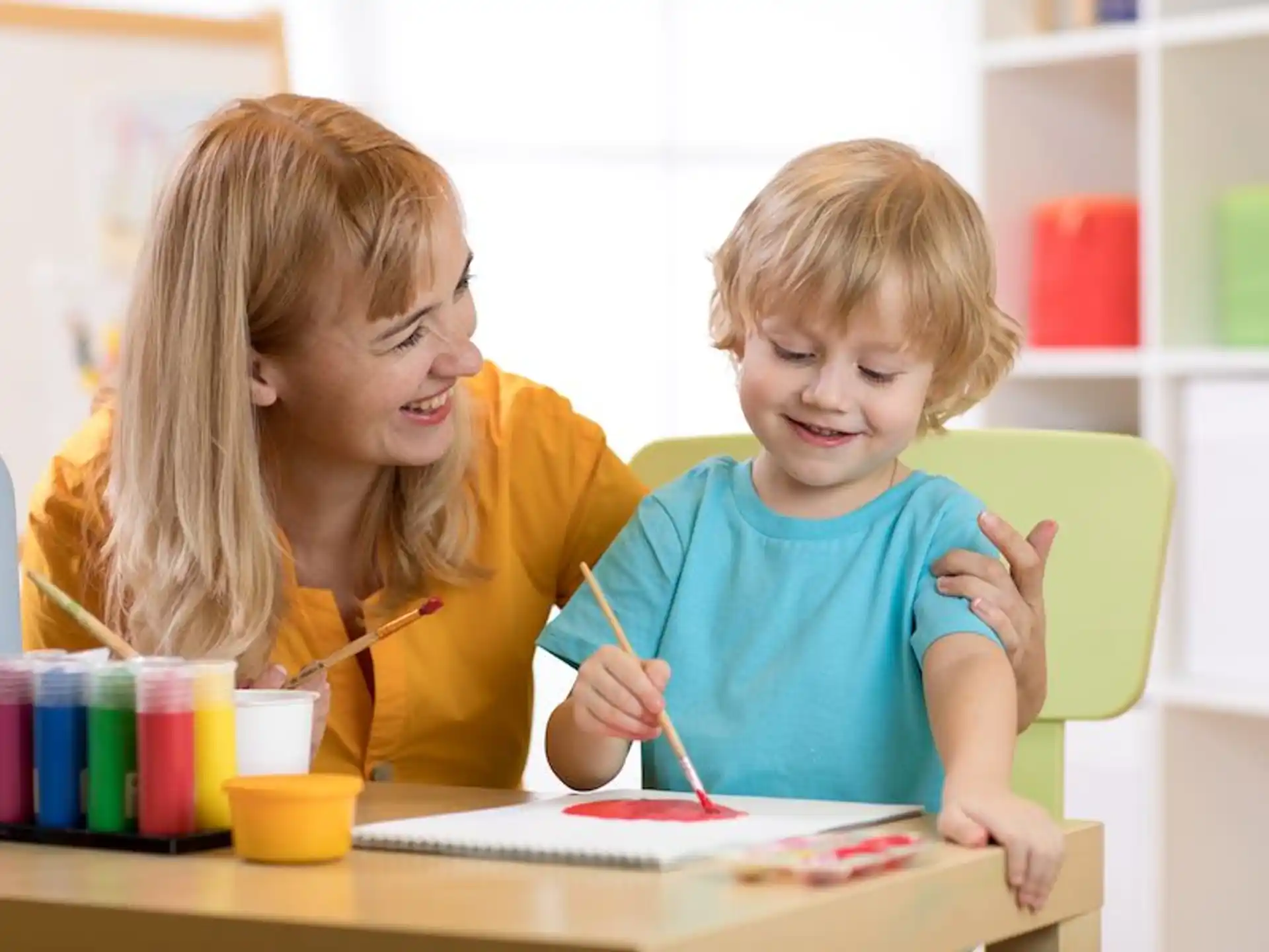 a person and a child painting
