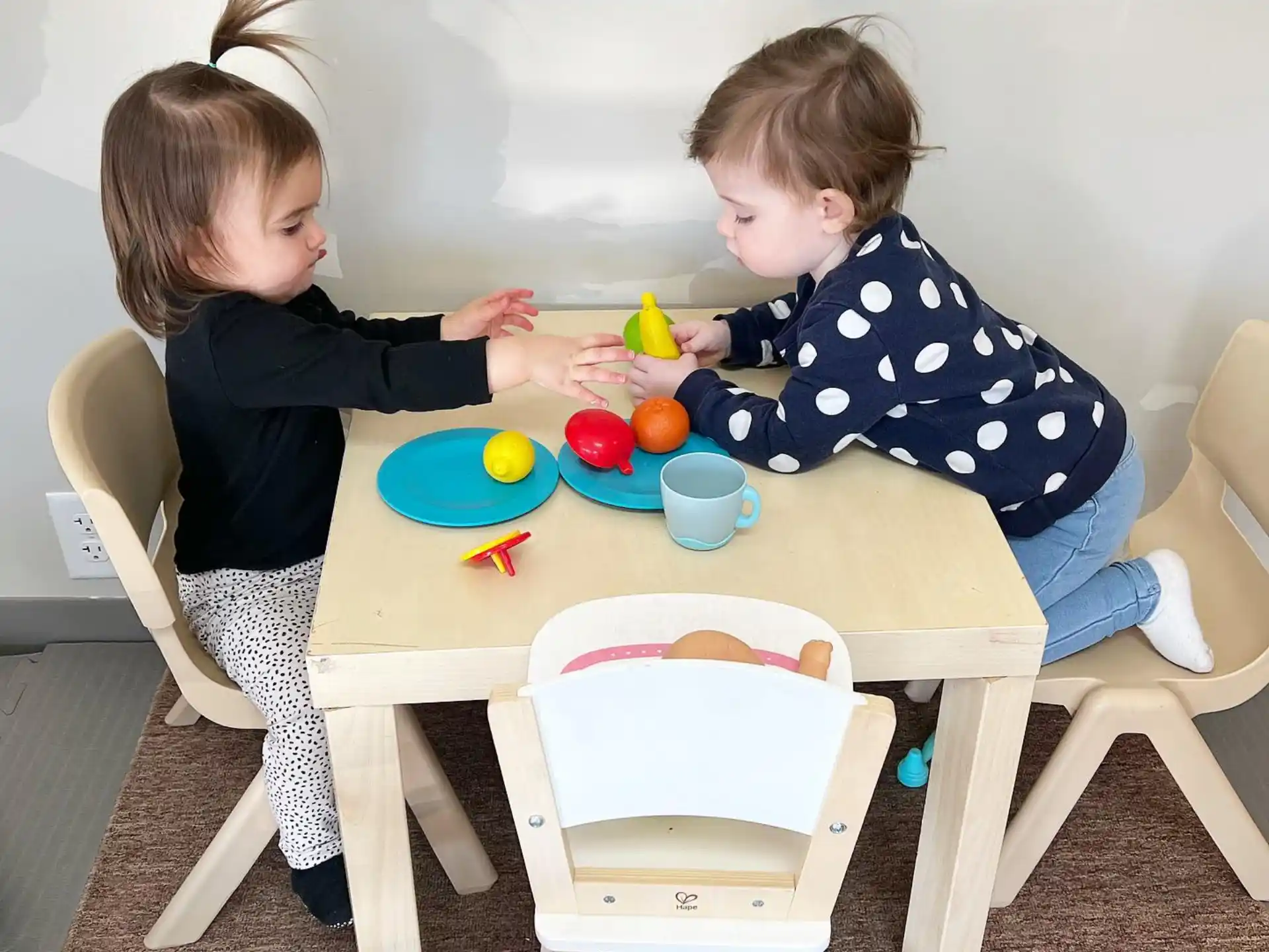 a couple of children playing with toys