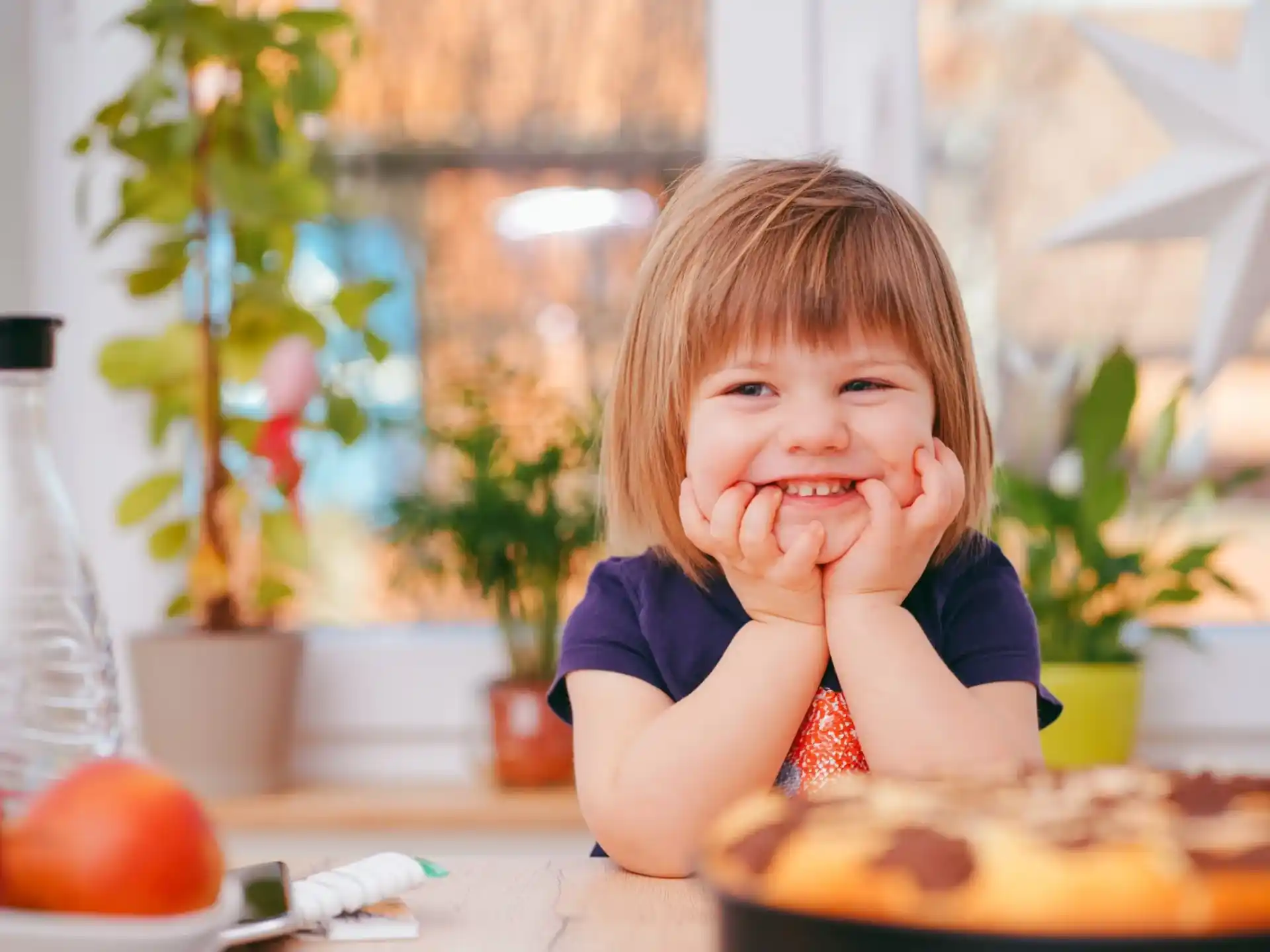 a little girl eating a cake