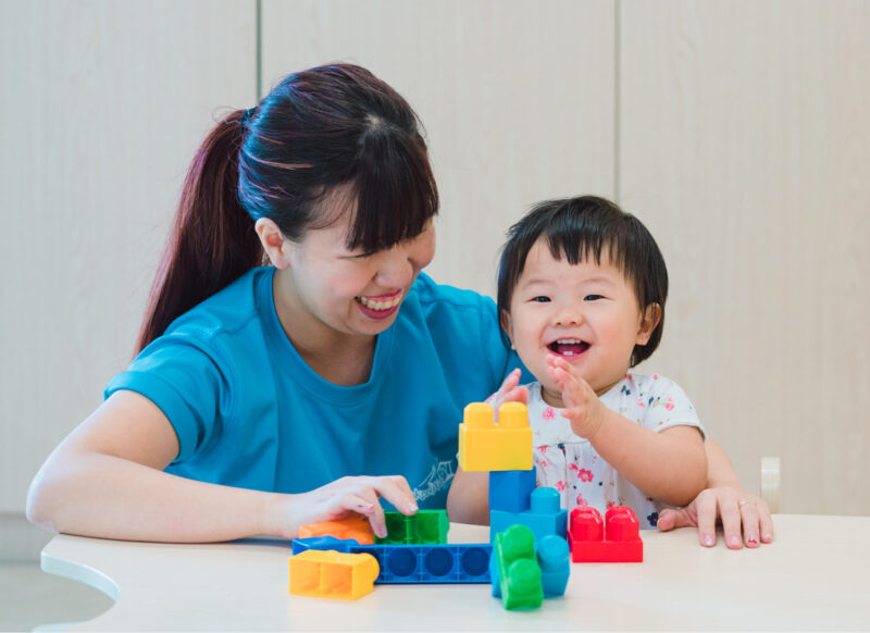 a person and a child playing with toys