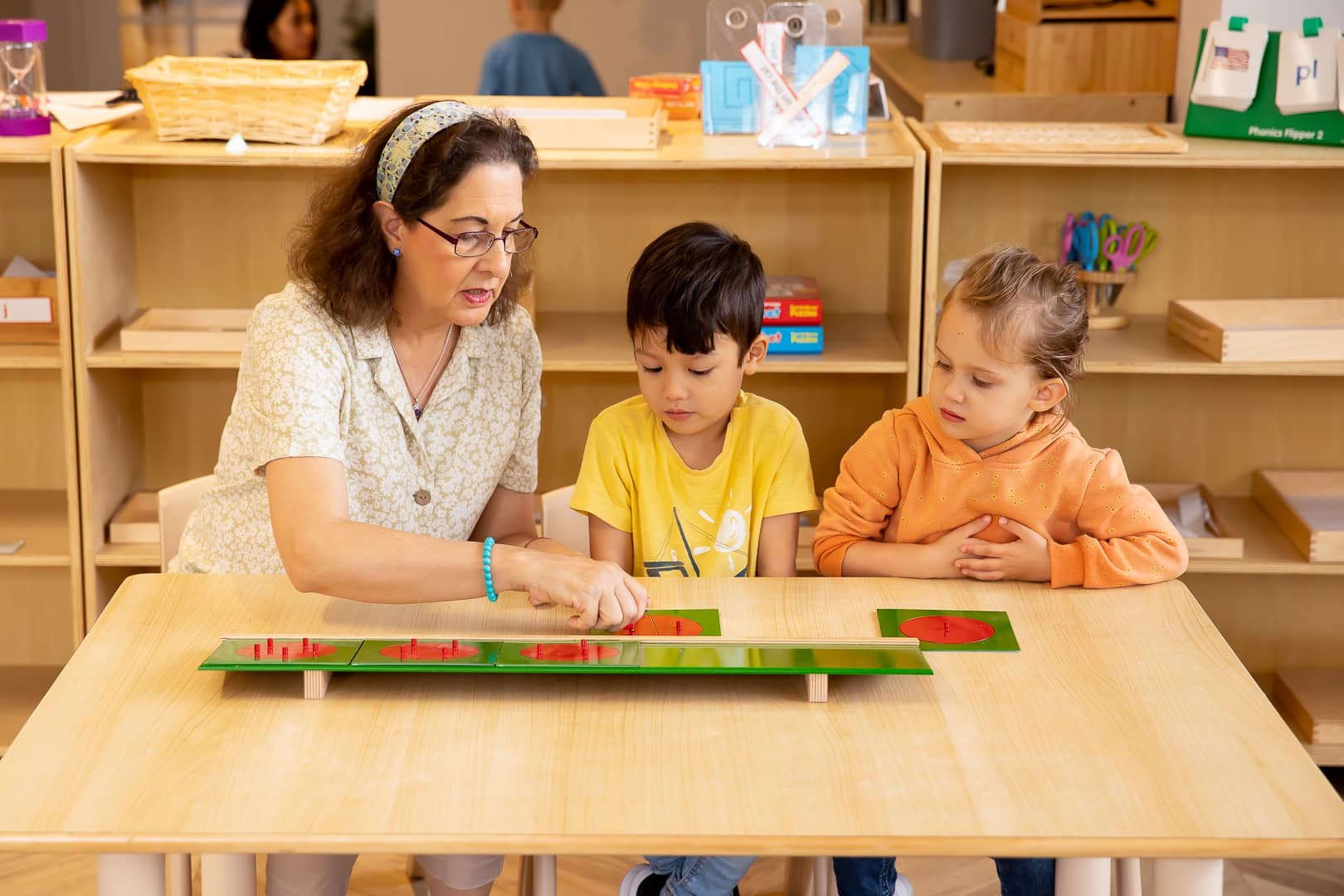 a person and two children sitting at a table