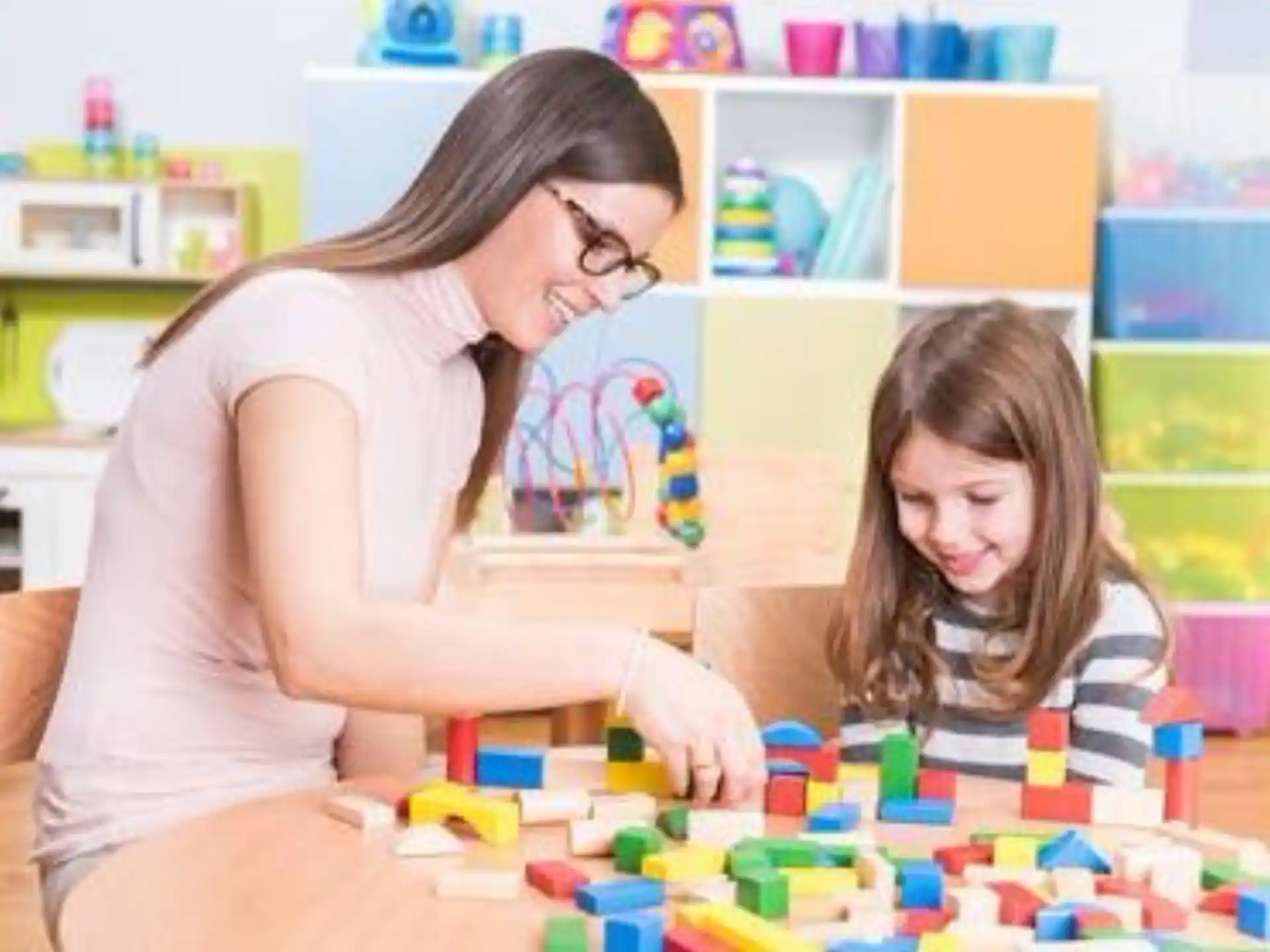 a person and a child playing with toys