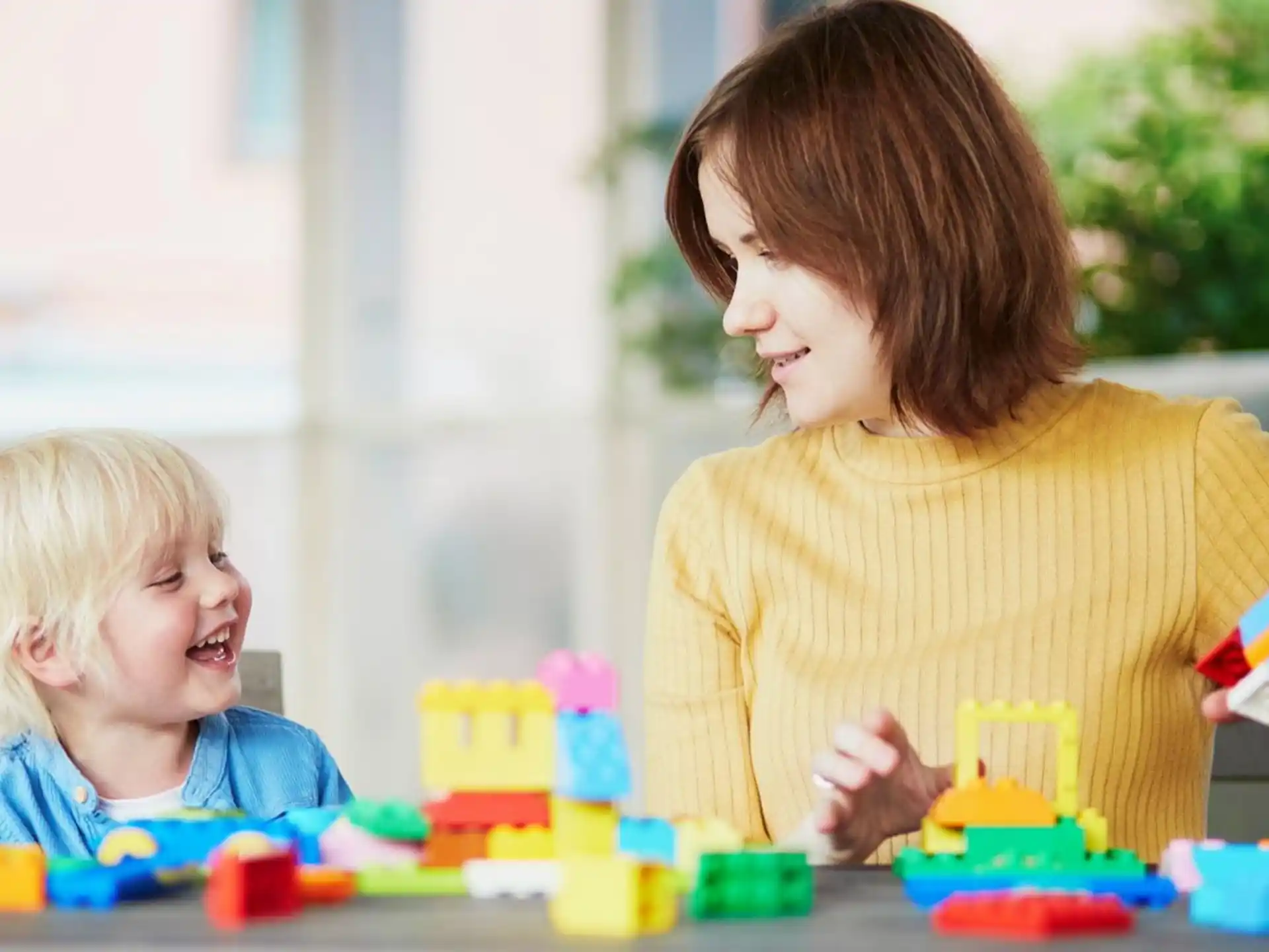 a person and a child playing with toys