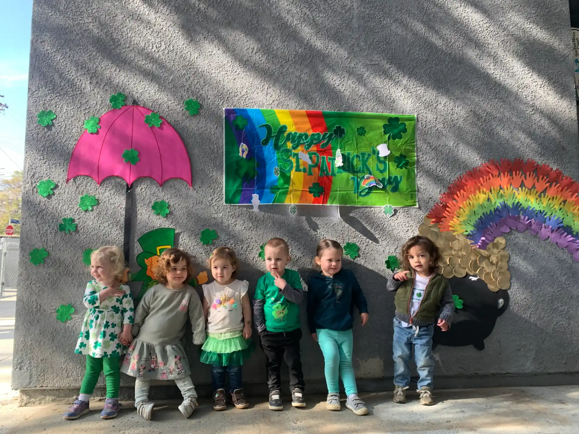 a group of children posing for a photo in front of a wall