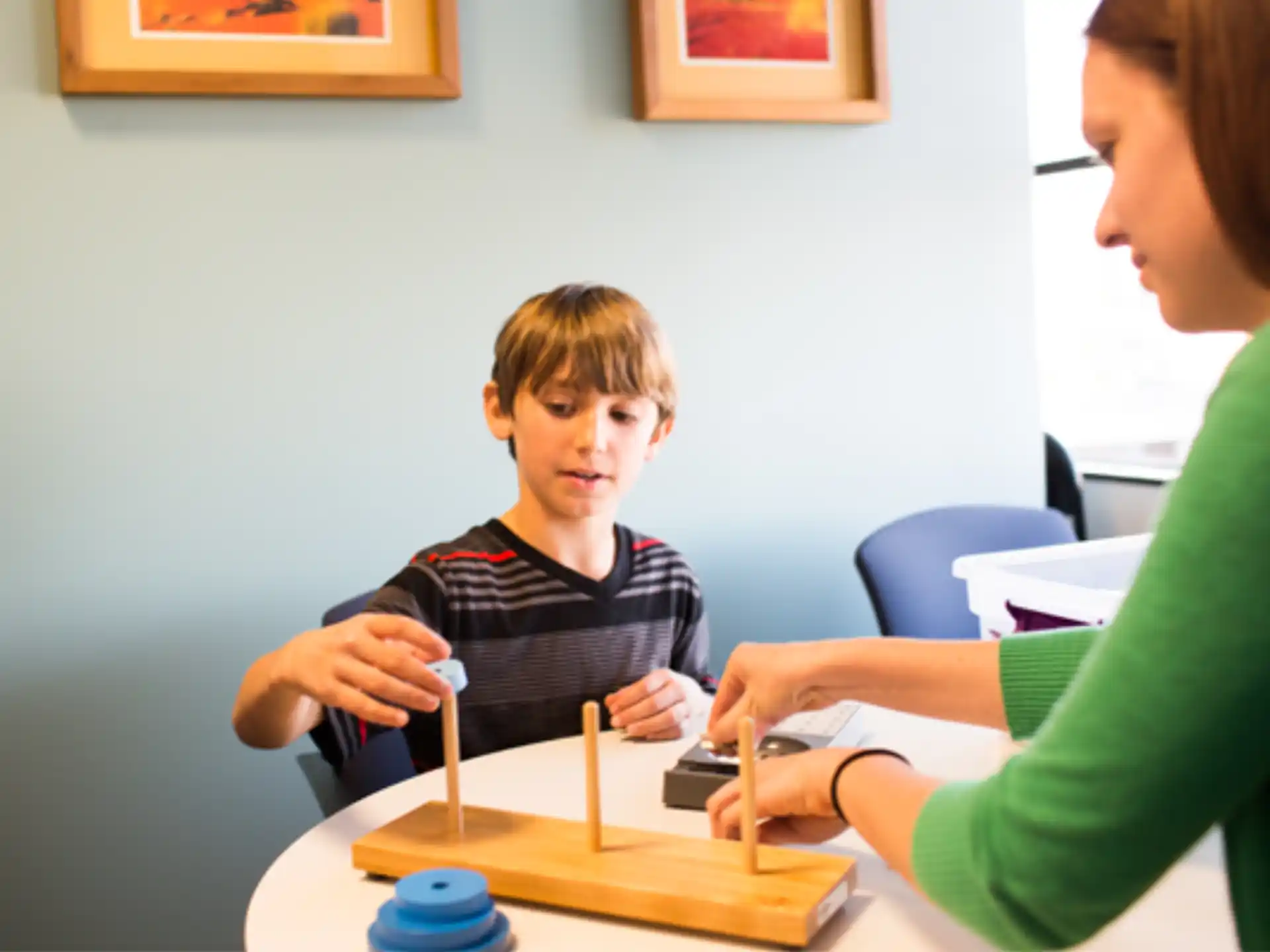 a person and a boy sitting at a table