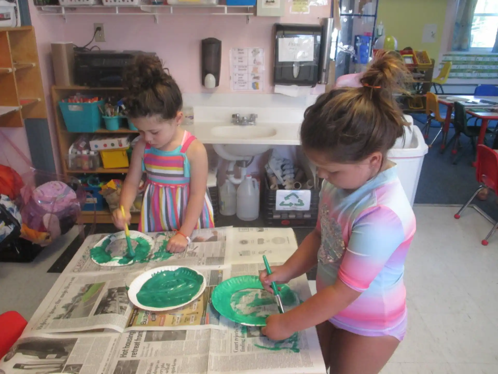 a couple of young girls playing with toys in a room