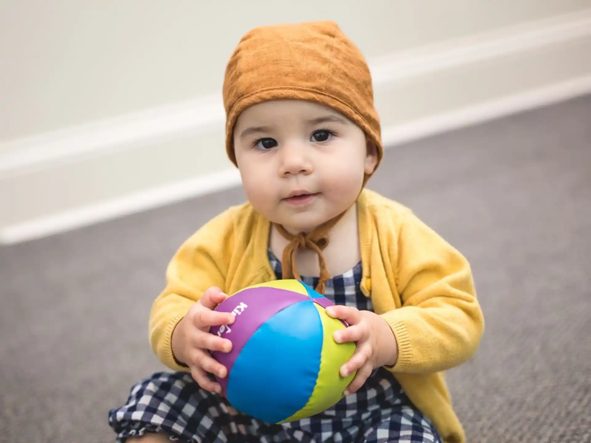 a baby holding a ball
