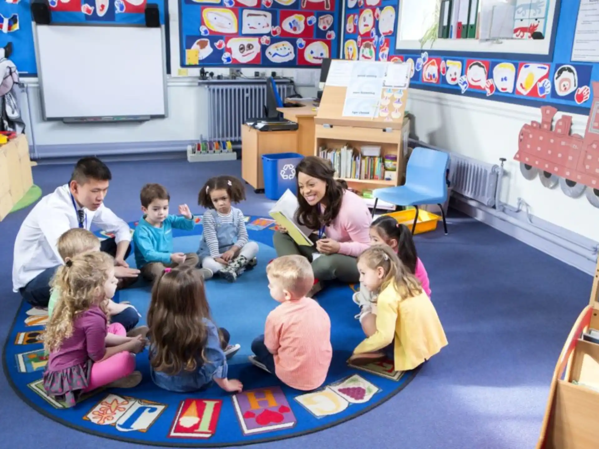 a group of children sitting on the floor in a classroom