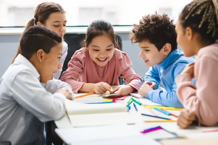 a group of children sitting at a table