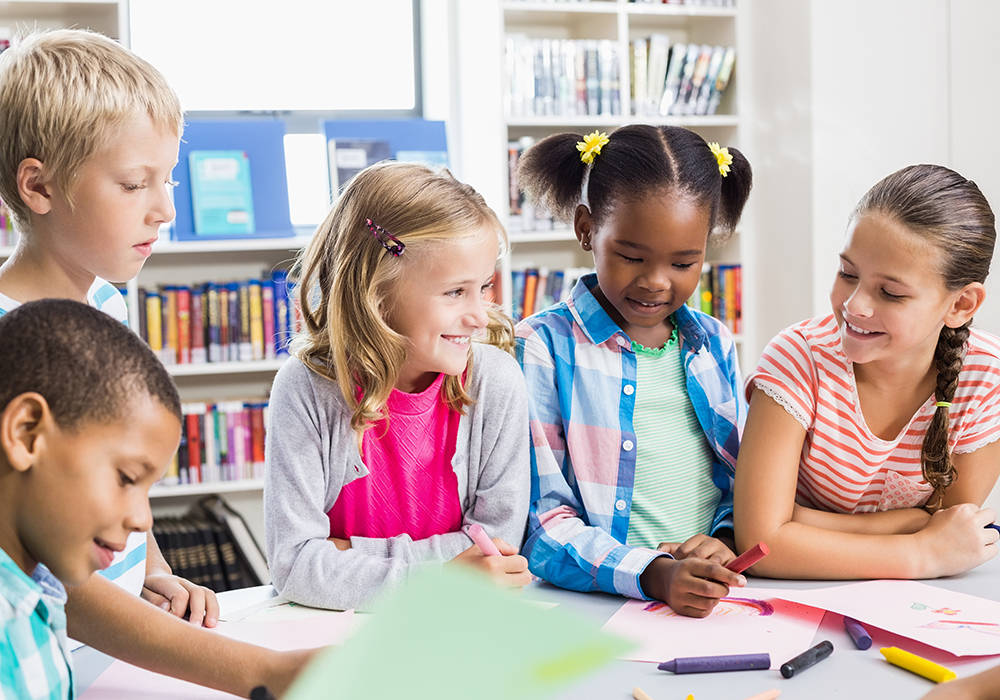 a group of children sitting at a table