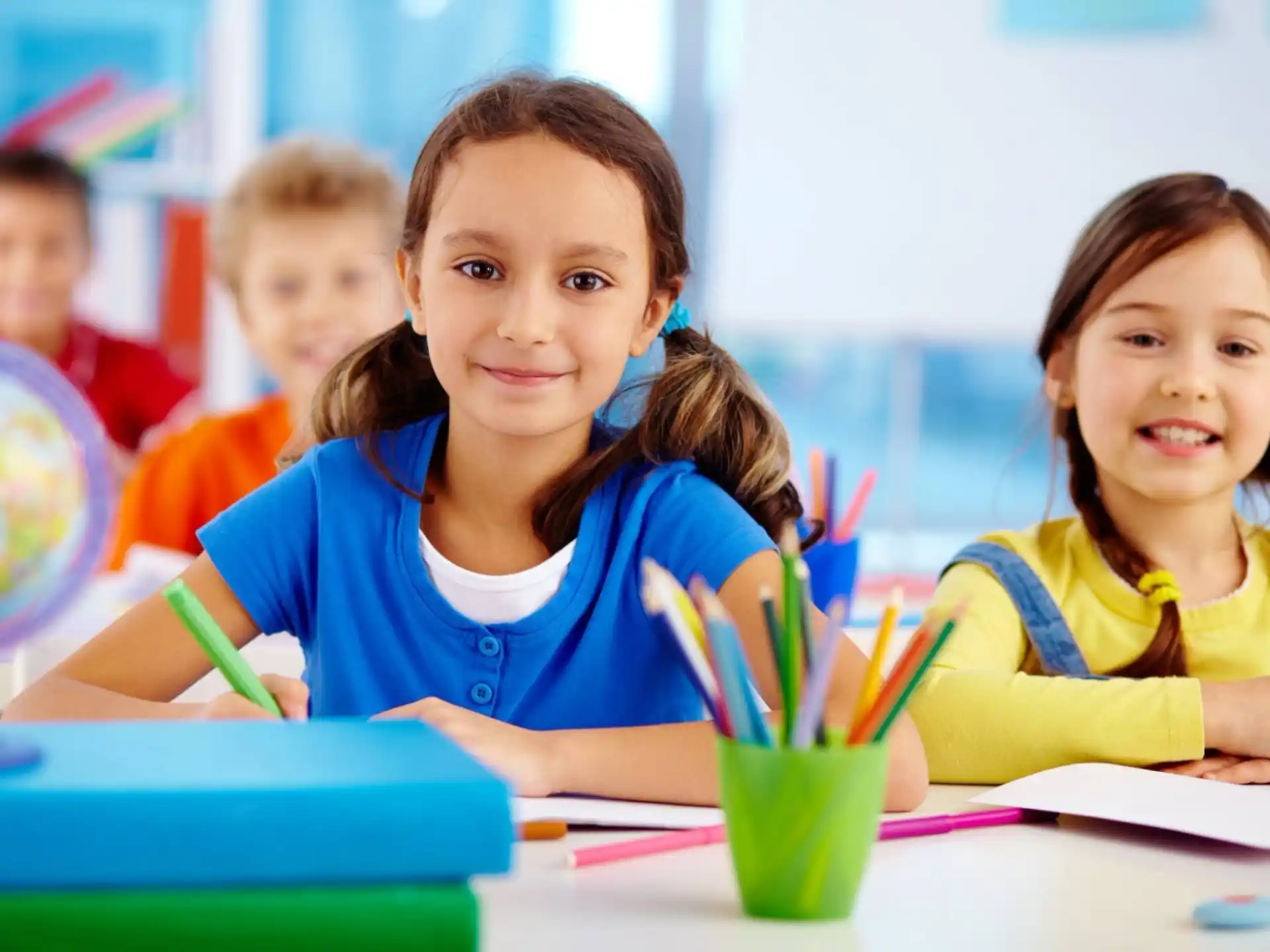 a few young girls sitting at a table