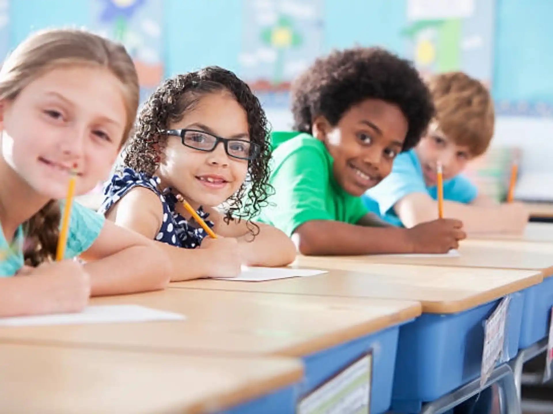 a group of children sitting at a table