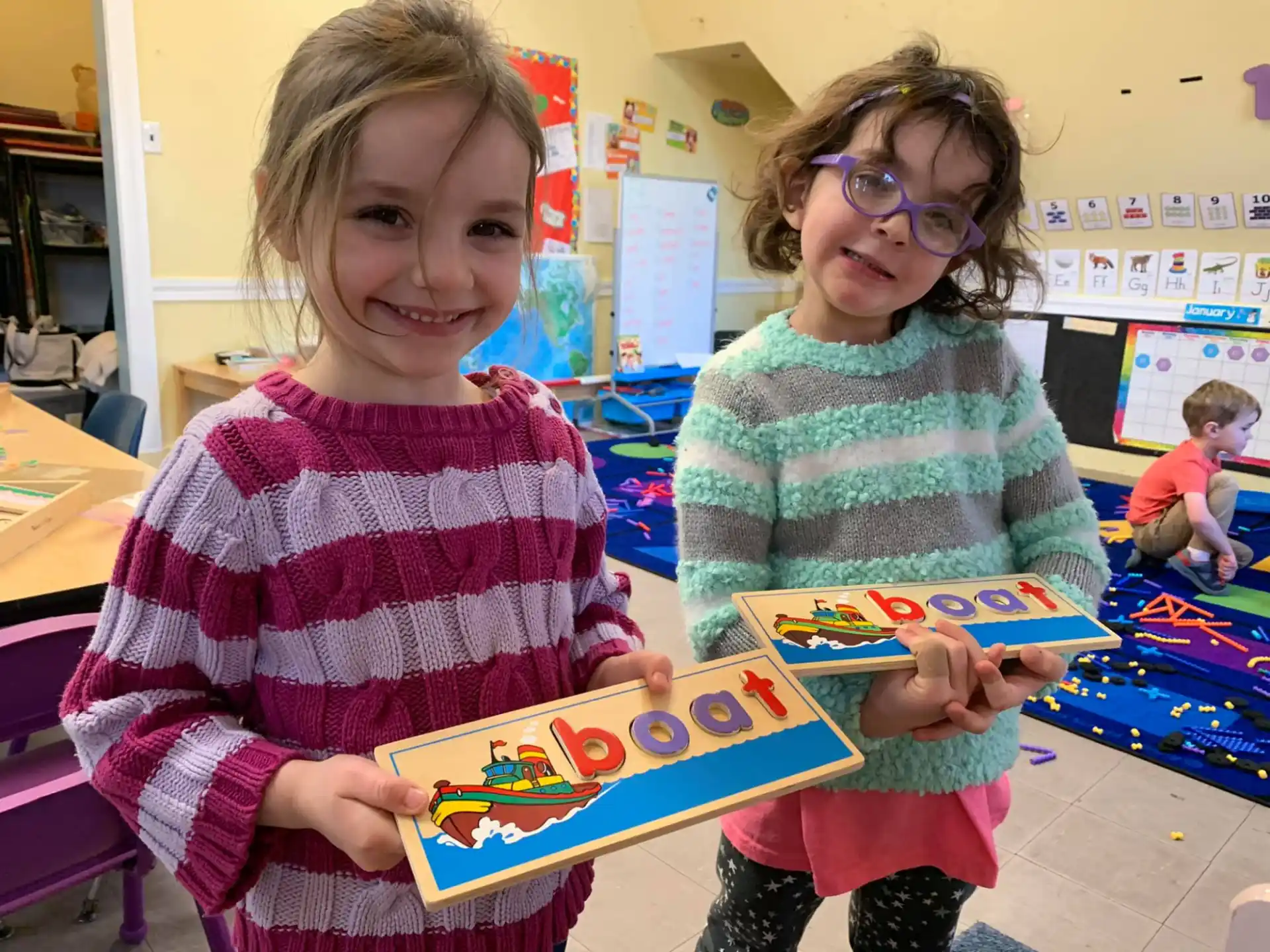 a couple of children holding a toy