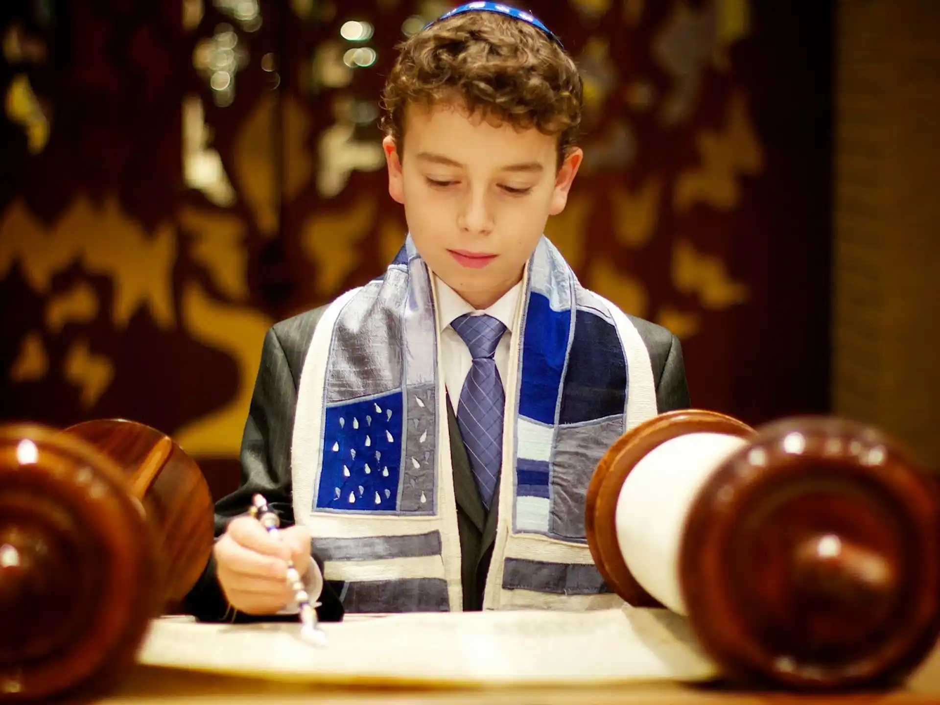 a boy wearing a suit and tie